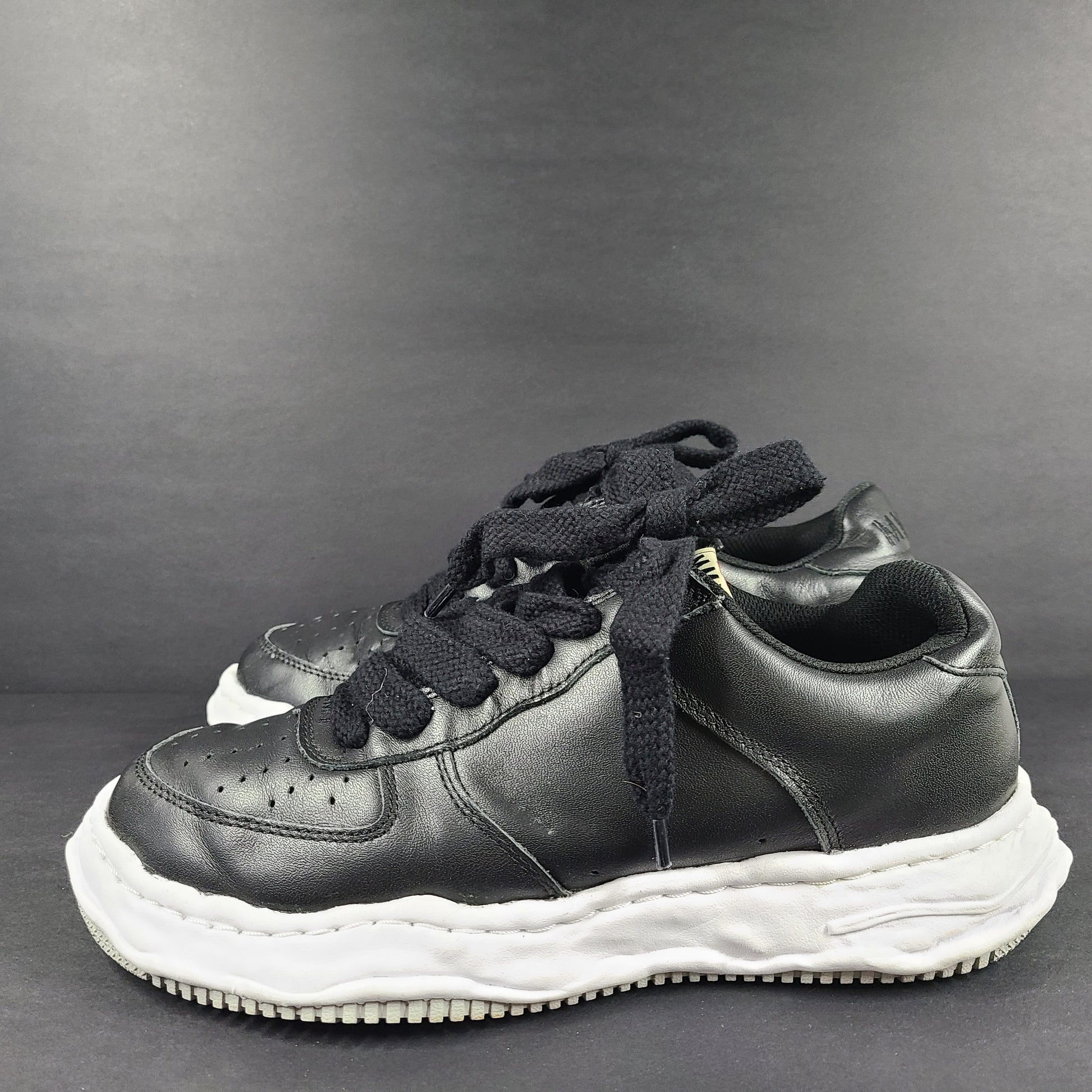 Black and white Maison Mihara Yasuhiro Wayne low-top leather sneakers with original sculpted OG sole and MMY branding.