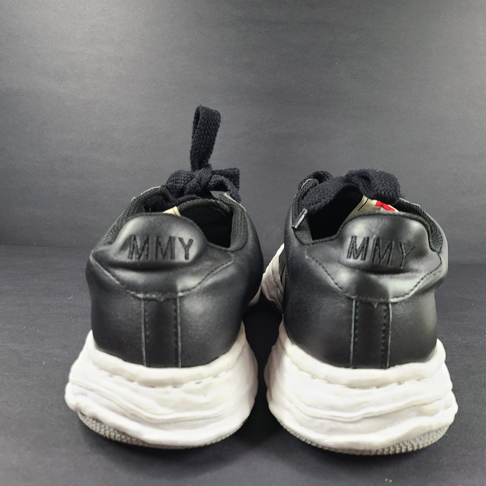 Black and white Maison Mihara Yasuhiro Wayne low-top leather sneakers with original sculpted OG sole and MMY branding.
