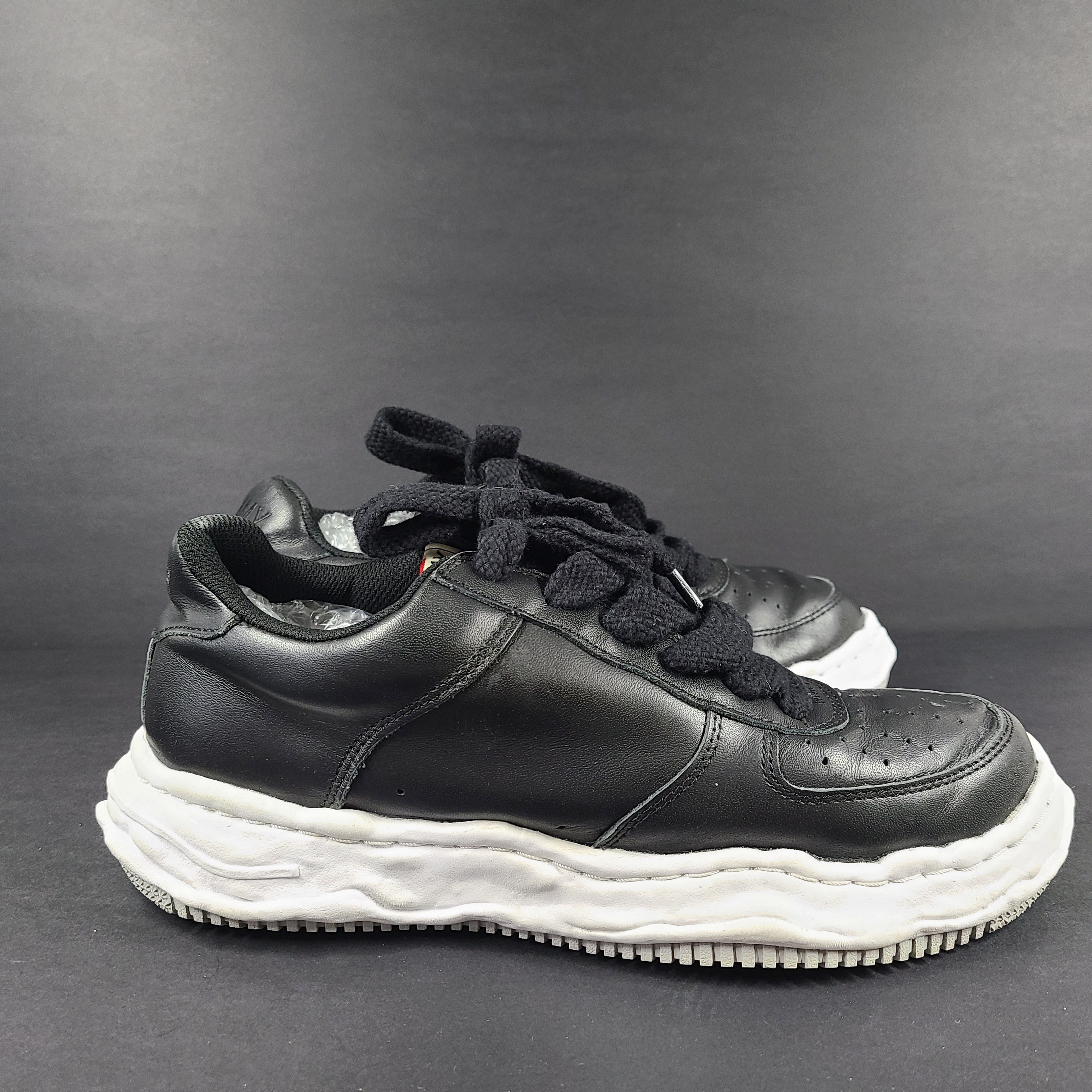 Black and white Maison Mihara Yasuhiro Wayne low-top leather sneakers with original sculpted OG sole and MMY branding.