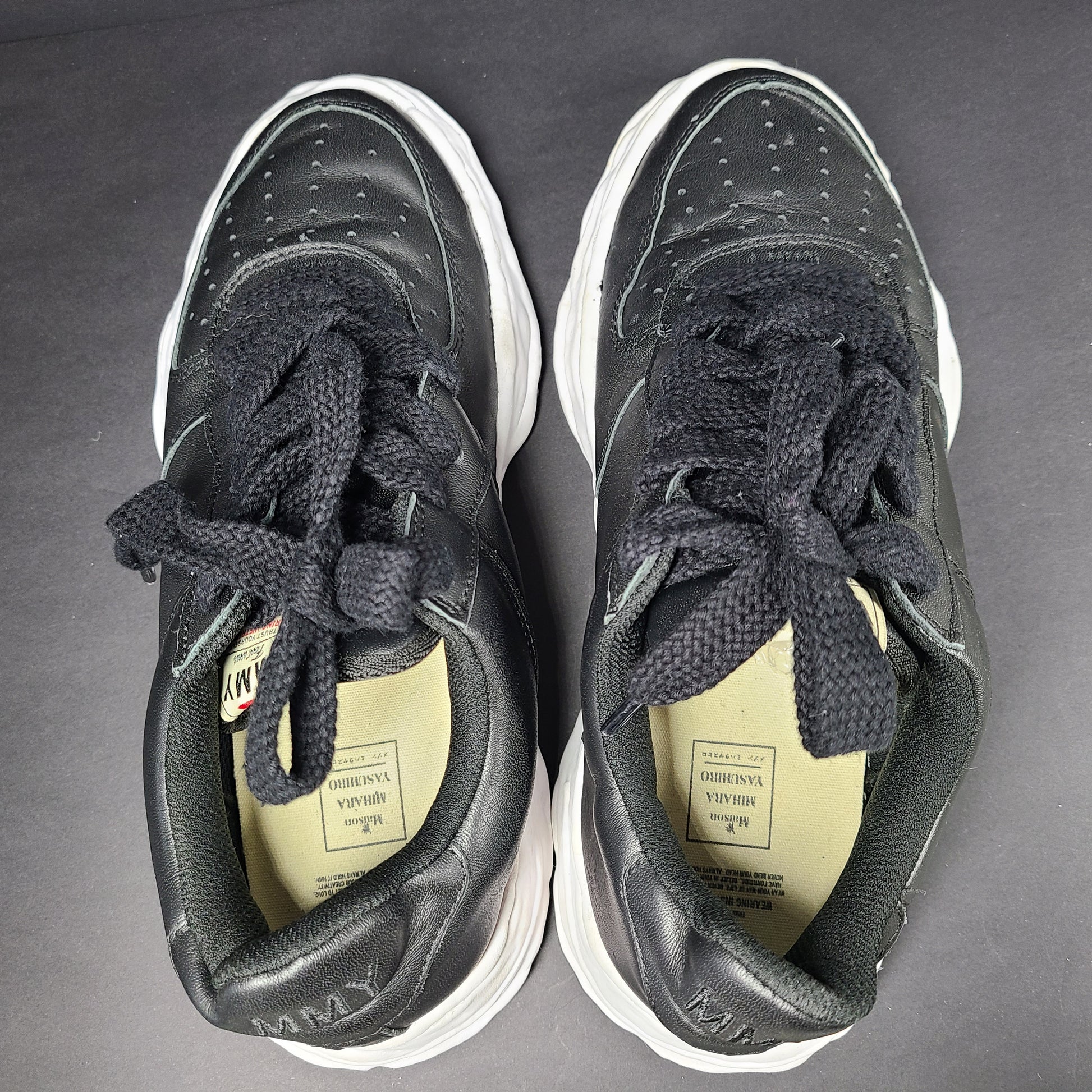 Black and white Maison Mihara Yasuhiro Wayne low-top leather sneakers with original sculpted OG sole and MMY branding.