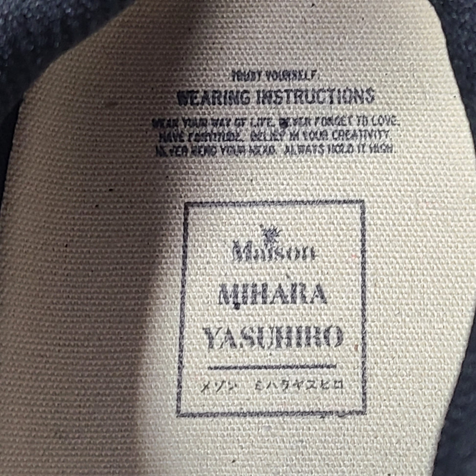 Black and white Maison Mihara Yasuhiro Wayne low-top leather sneakers with original sculpted OG sole and MMY branding.