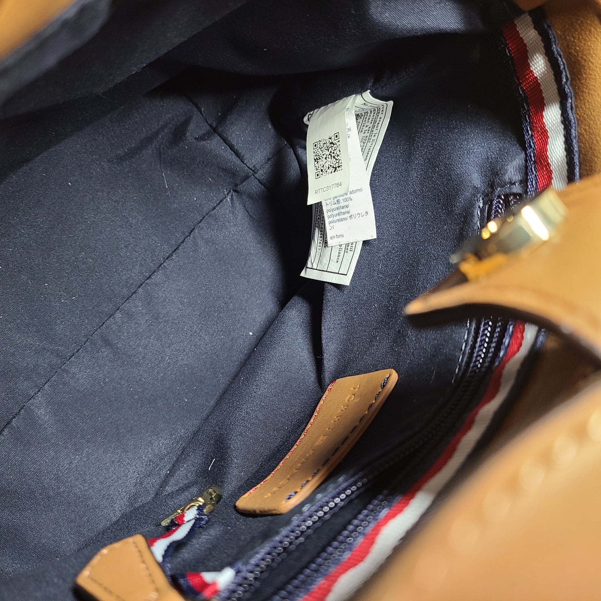 Tommy Hilfiger tan satchel with multicolor accents and signature branding for everyday use.