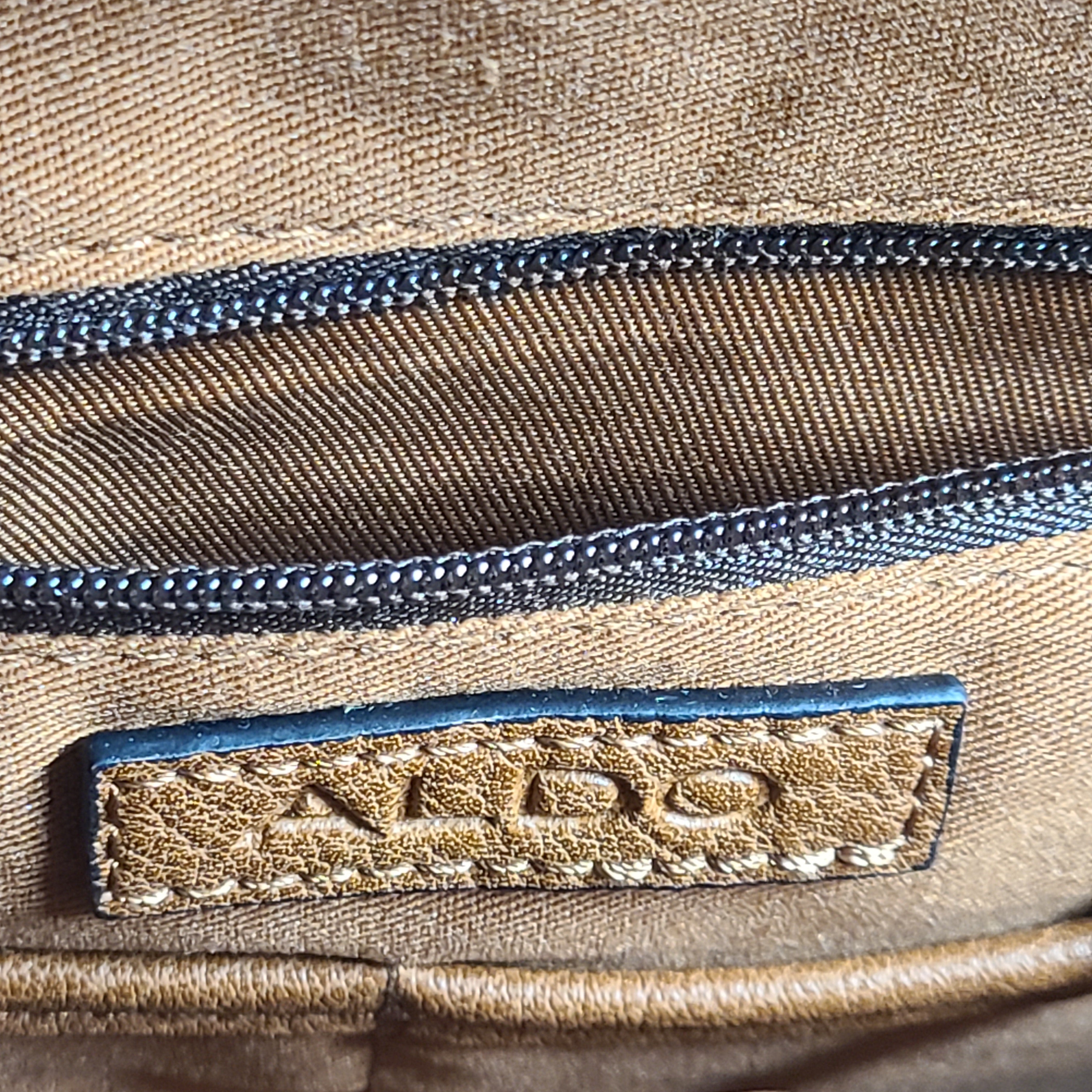 Brown ALDO messenger bag with adjustable strap and luggage tag designed to carry up to a 15-inch laptop.
