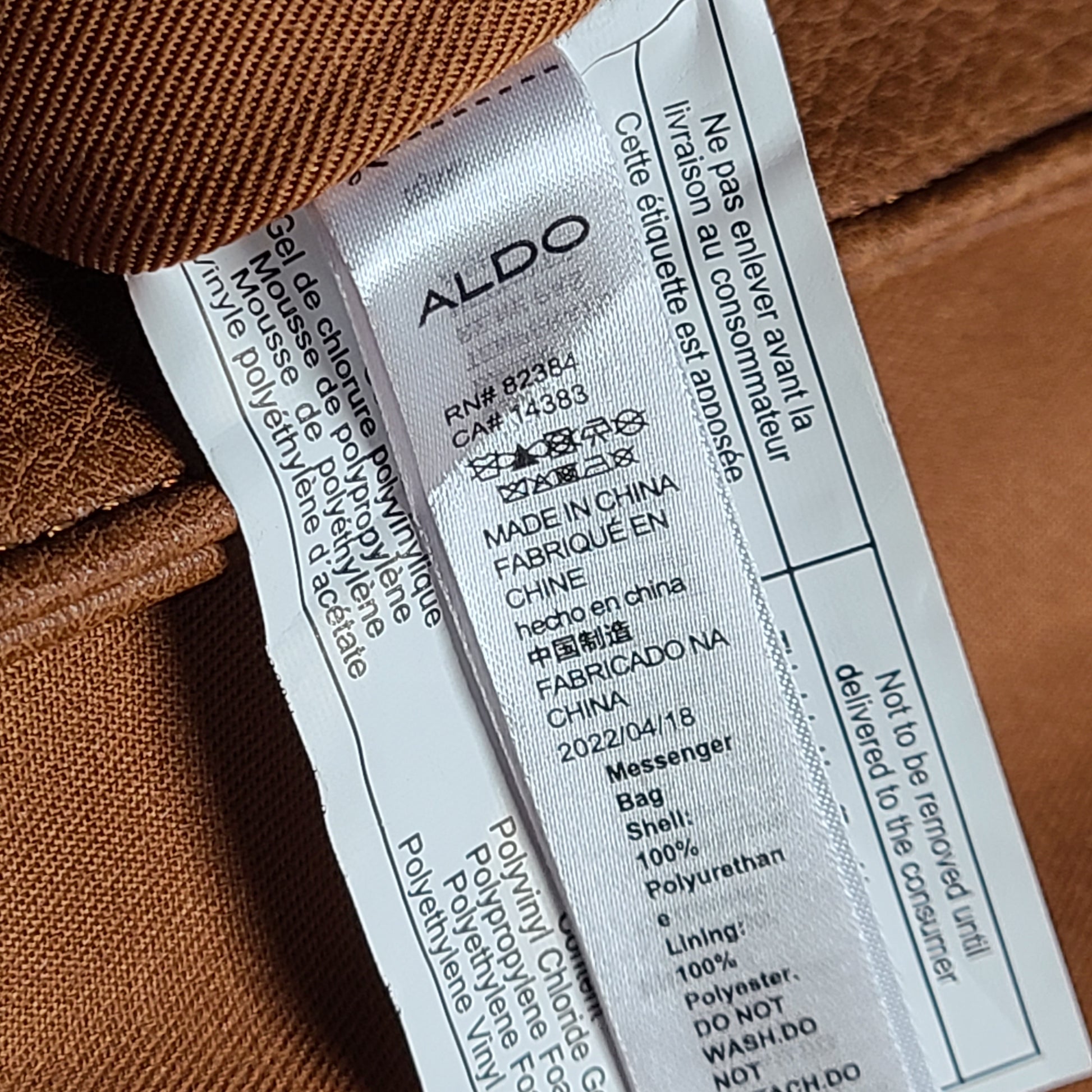 Brown ALDO messenger bag with adjustable strap and luggage tag designed to carry up to a 15-inch laptop.