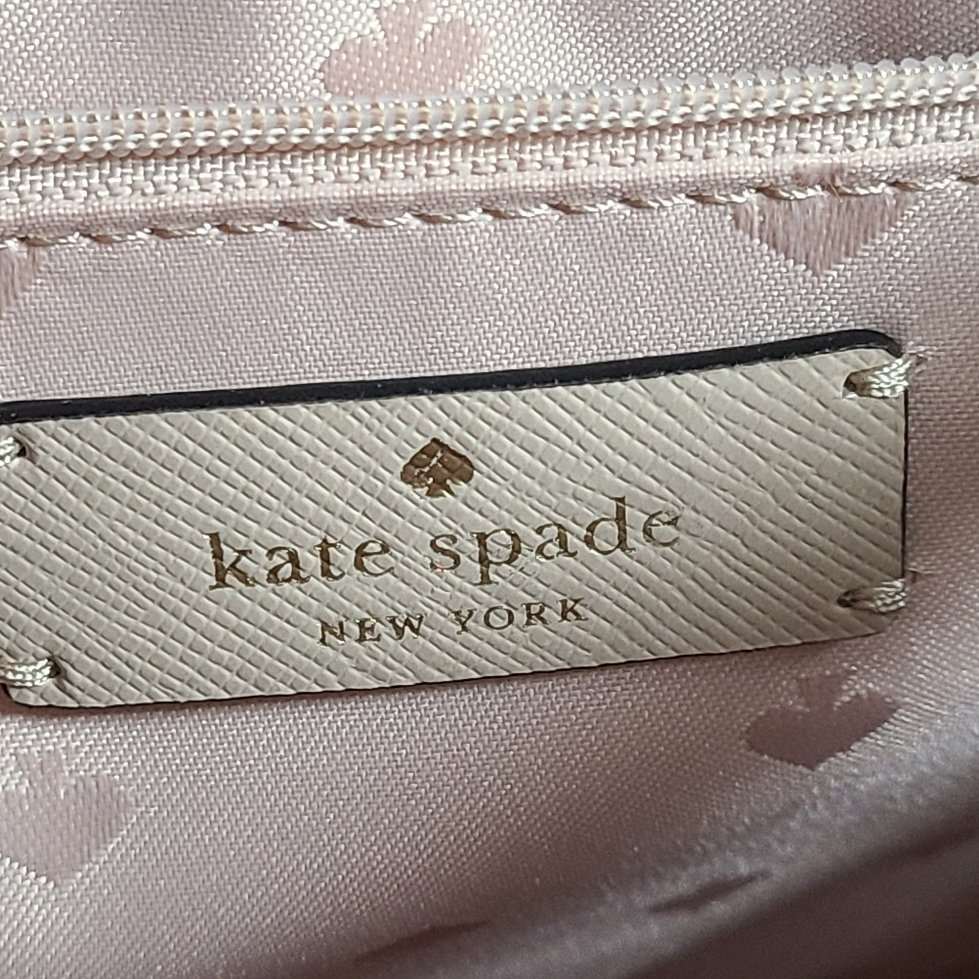 Kate Spade New York beige and black tote with shoulder strap and interior logo label.