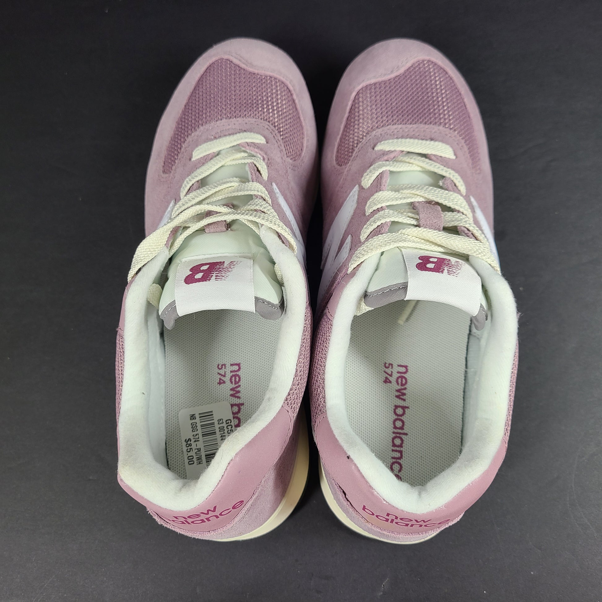 New Balance 574 kids pink and white lace-up sneaker in US size 6 with classic retro styling.
