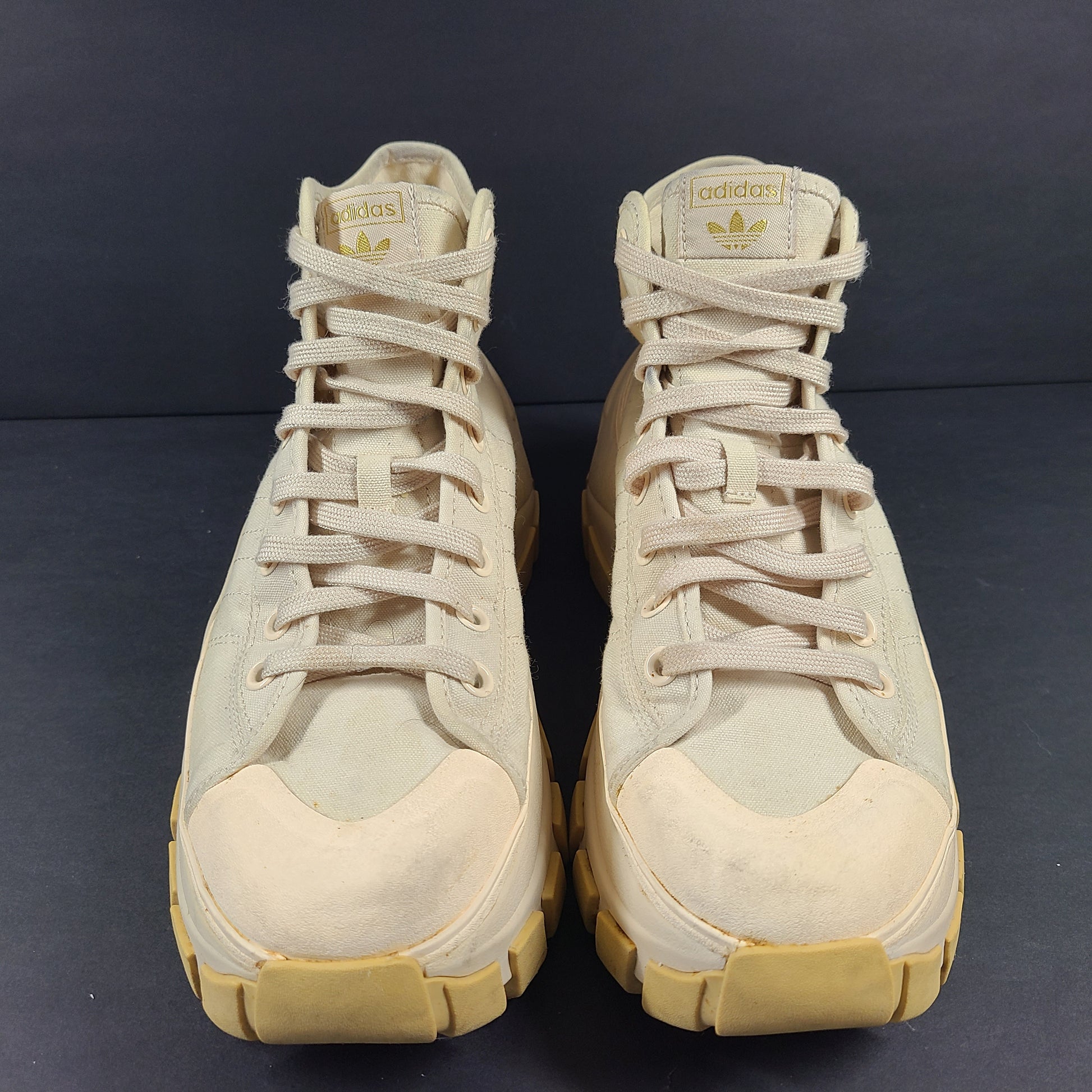 Adidas Nizza Hi XY22 beige high-top sneakers with a platform profile and gum outsole.