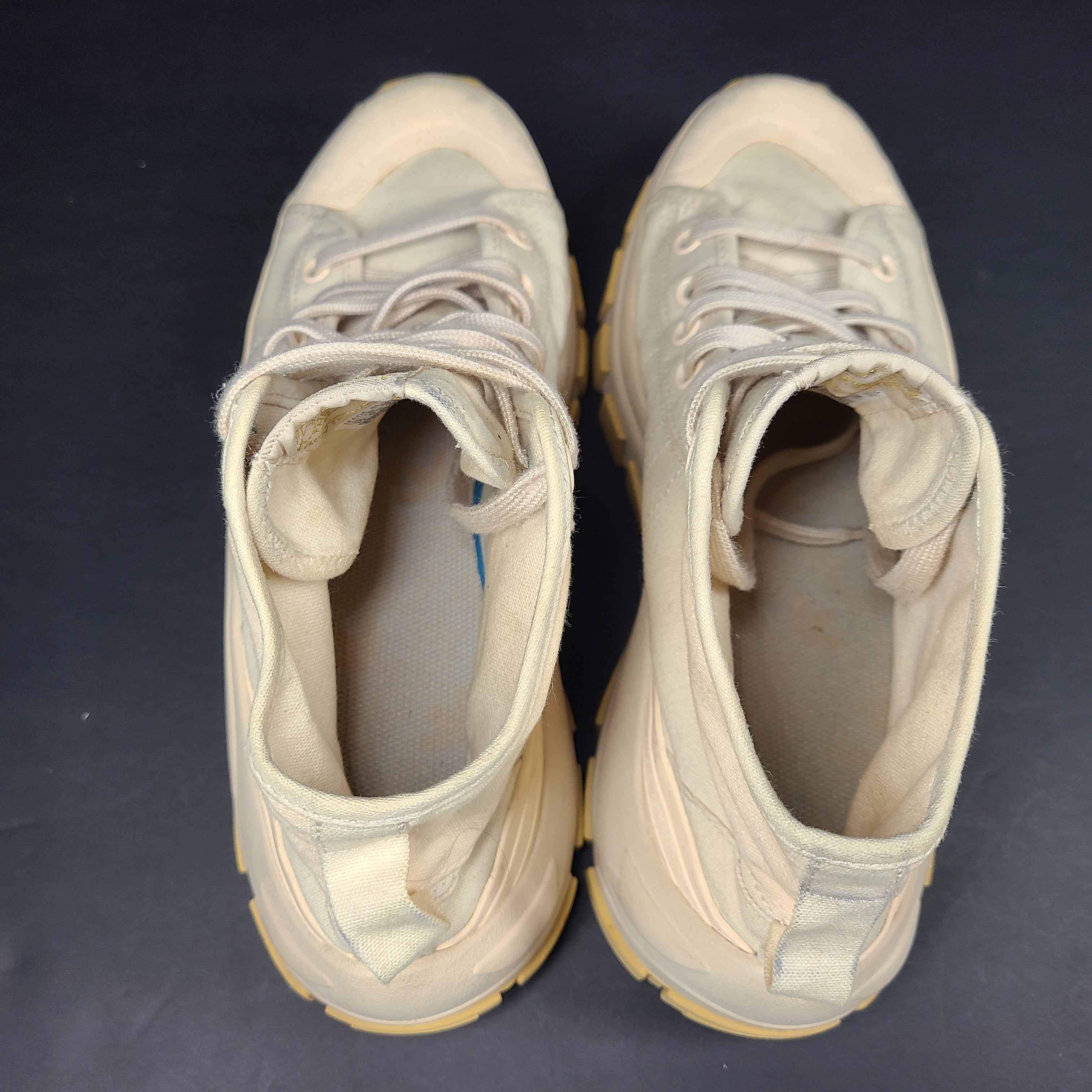 Adidas Nizza Hi XY22 beige high-top sneakers with a platform profile and gum outsole.