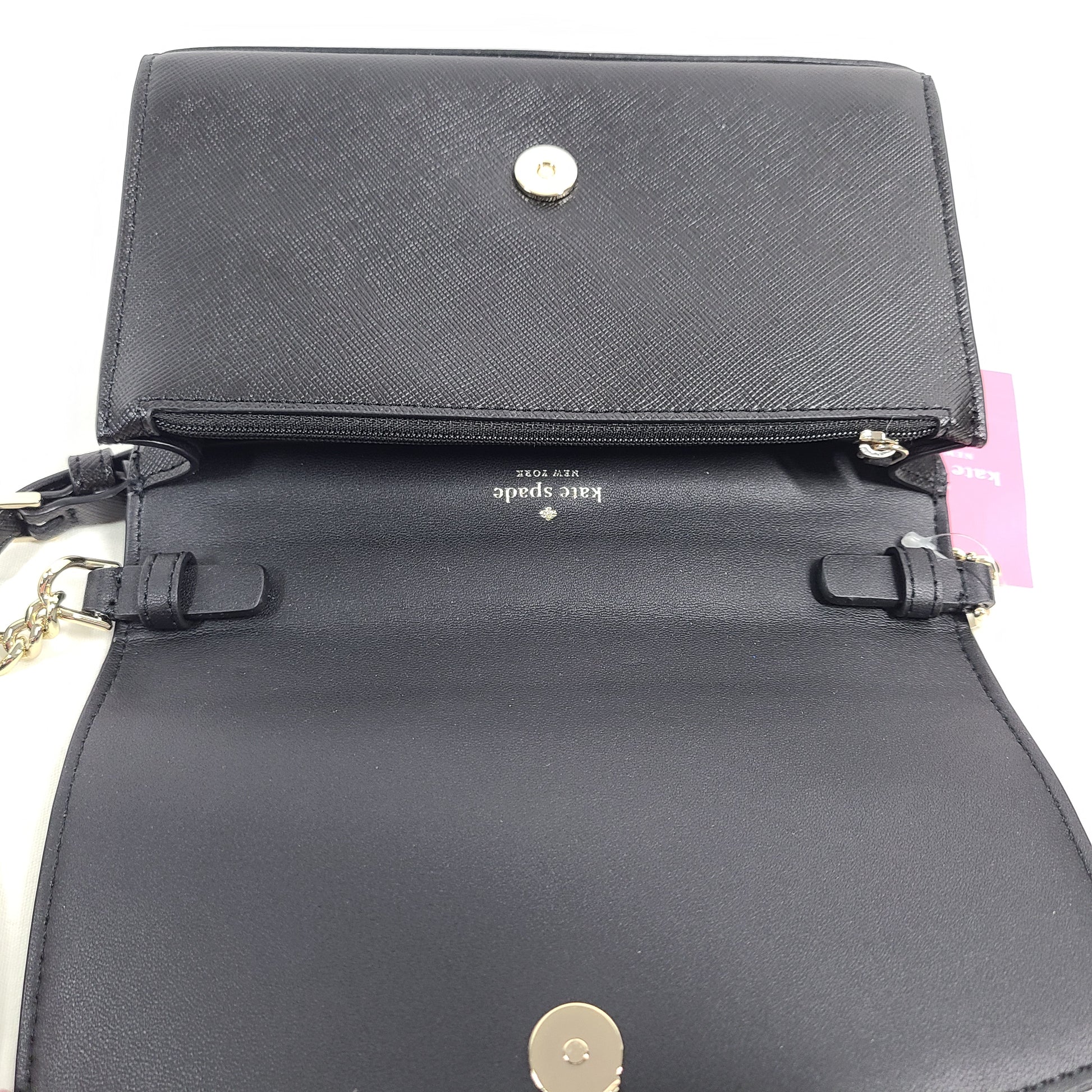 Kate Spade Staci small flip crossbody in black saffiano leather with a sleek silhouette and adjustable strap.