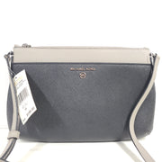 A Michael Kors AB-2204 crossbody bag in gray and beige with an attached strap and clean modern silhouette.