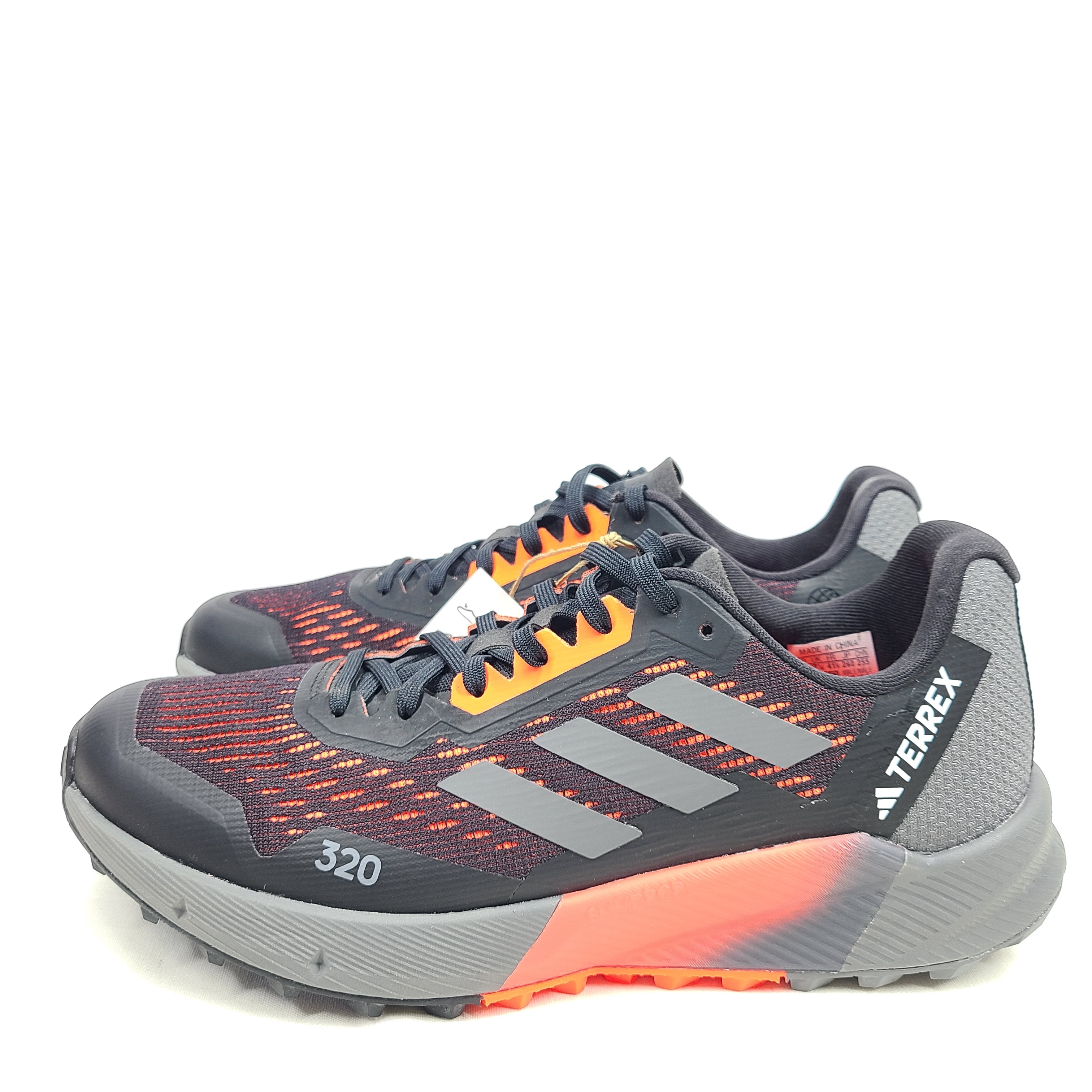 Black, orange, and gray Adidas Terrex Agravic Flow trail running shoe in US size 8 with responsive cushioning and a grippy outsole.