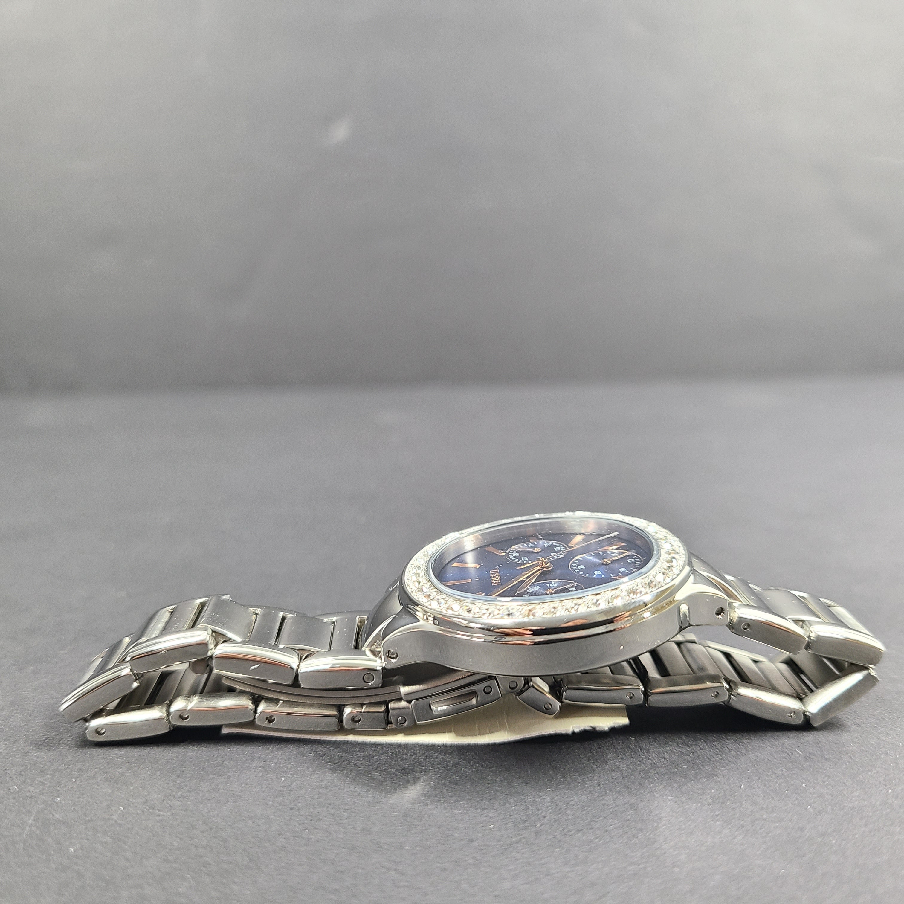 Sleek stainless-steel Fossil wristwatch with a blue dial and a slim 9mm case.