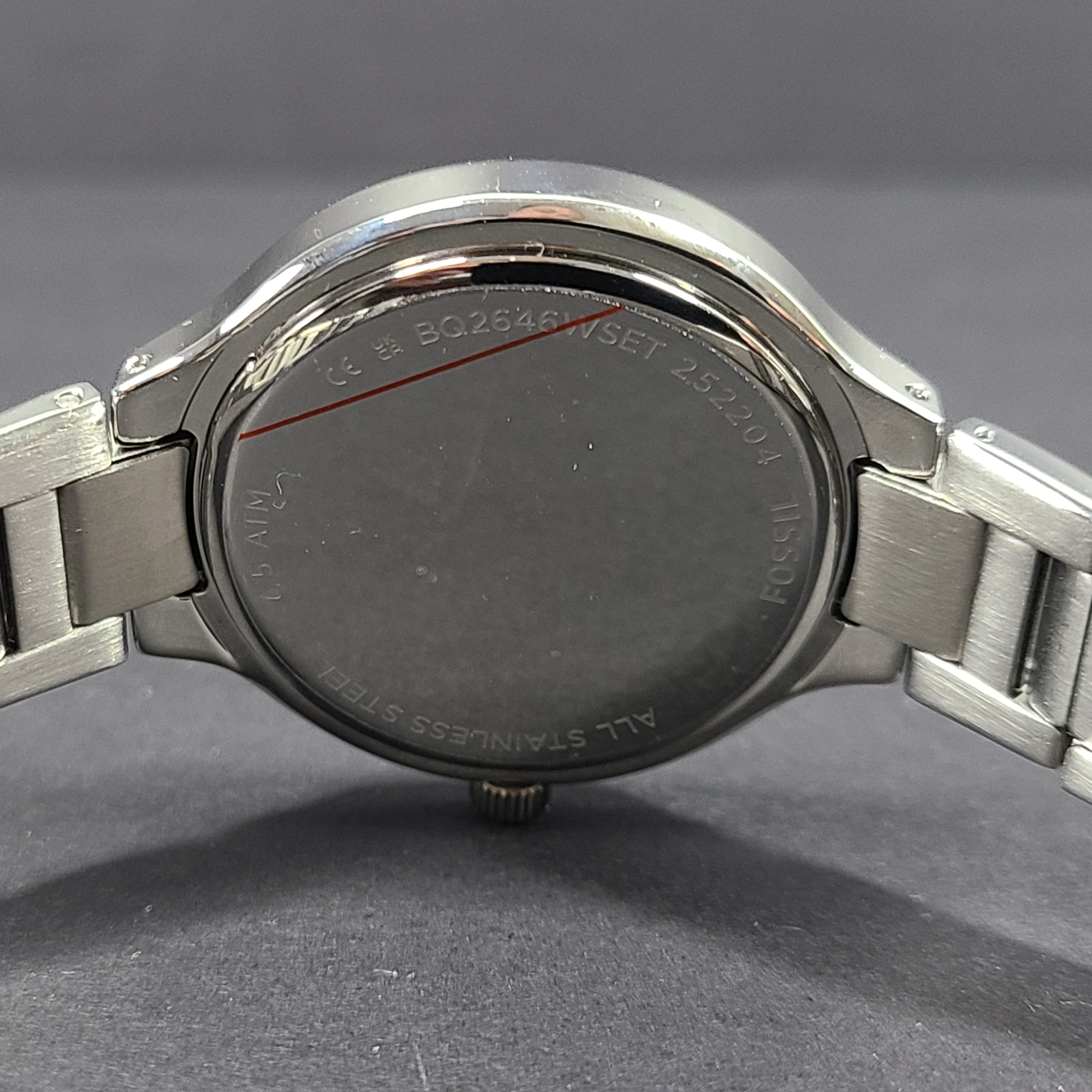 Sleek stainless-steel Fossil wristwatch with a blue dial and a slim 9mm case.