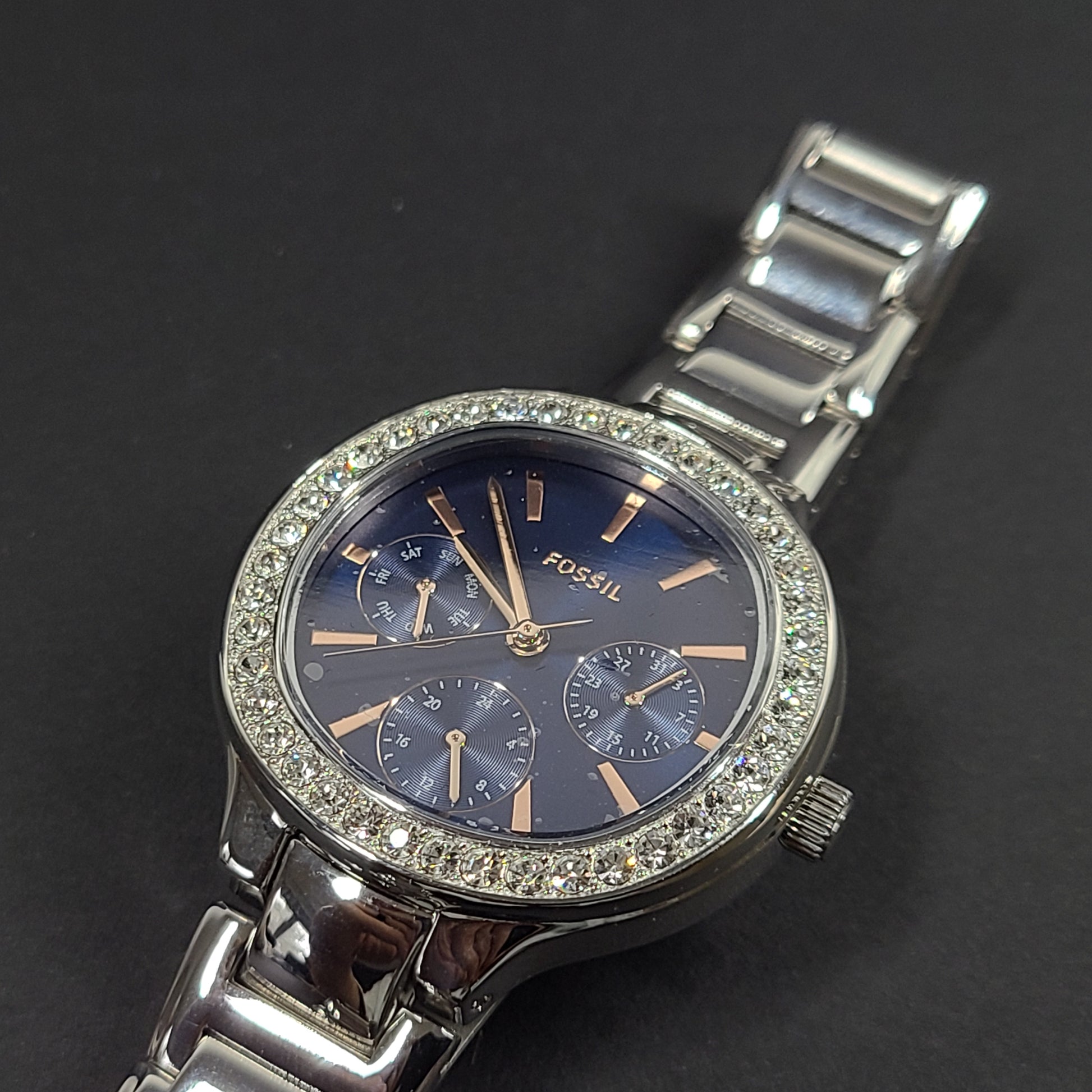 Sleek stainless-steel Fossil wristwatch with a blue dial and a slim 9mm case.