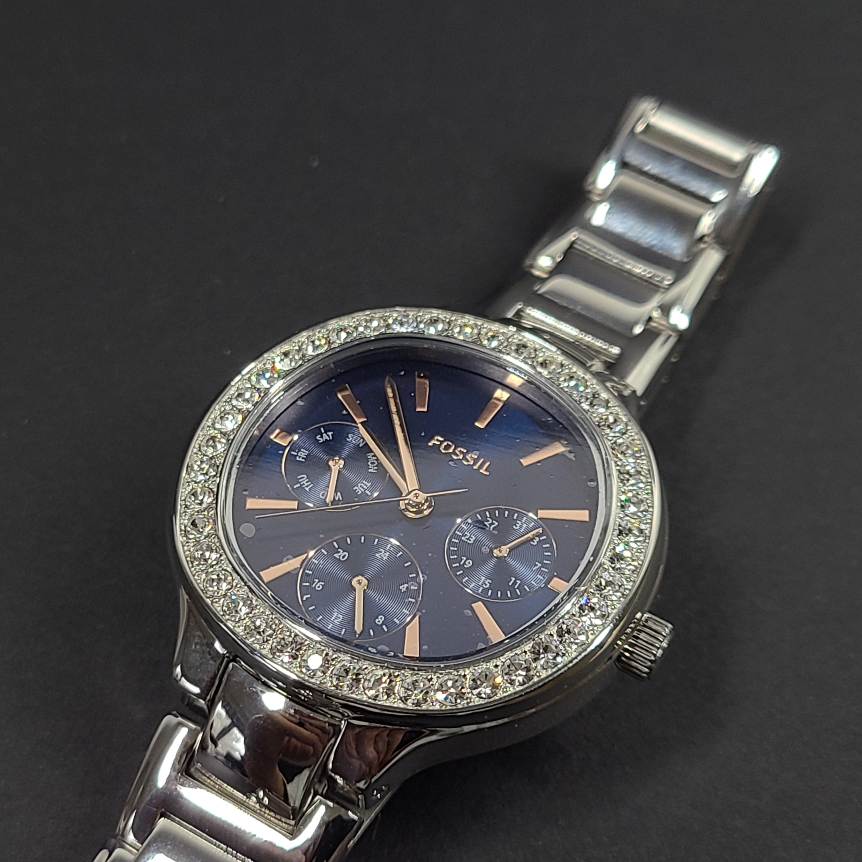 Sleek stainless-steel Fossil wristwatch with a blue dial and a slim 9mm case.