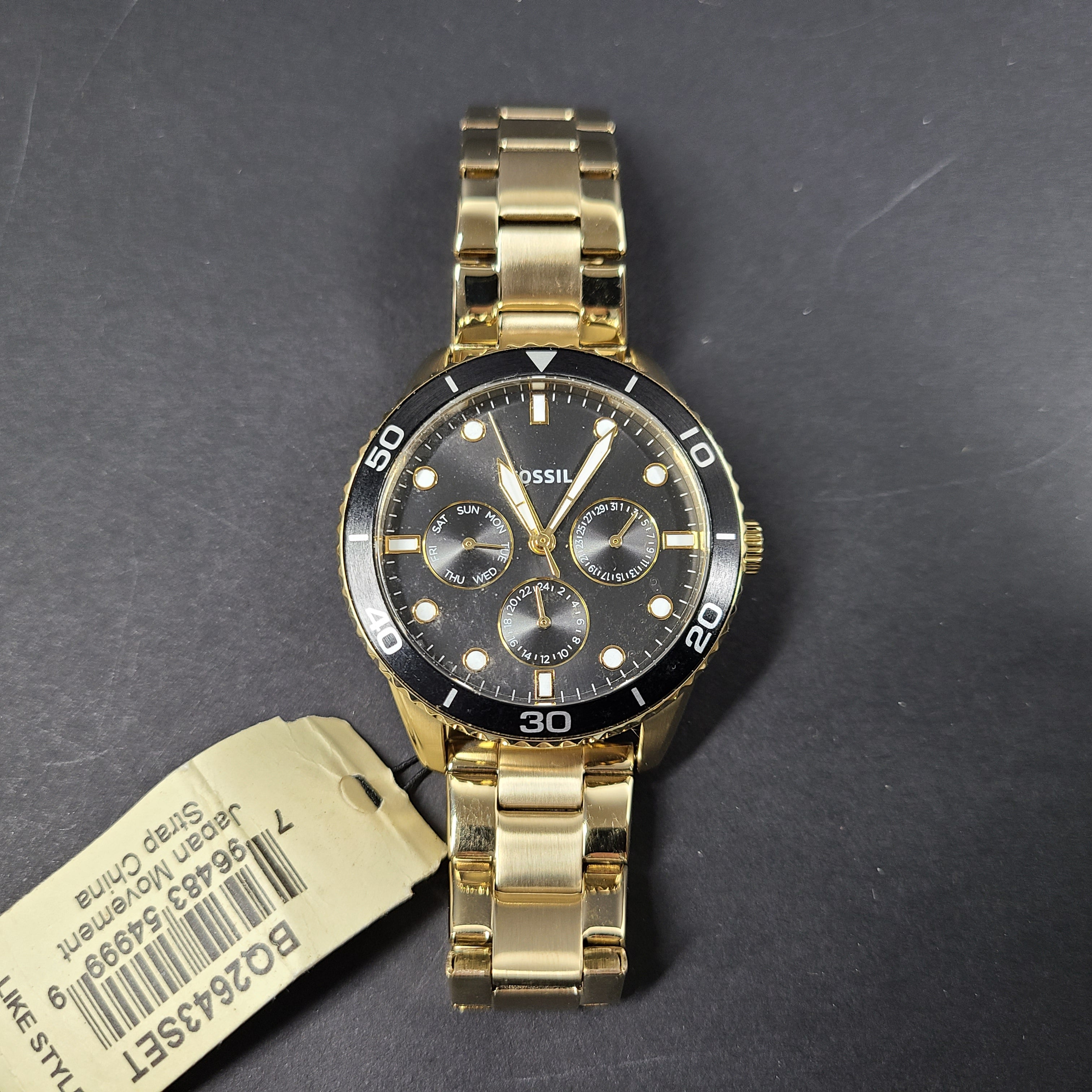 Gold-tone stainless steel his-and-her multifunction watch set with black sunray dials and interchangeable straps.