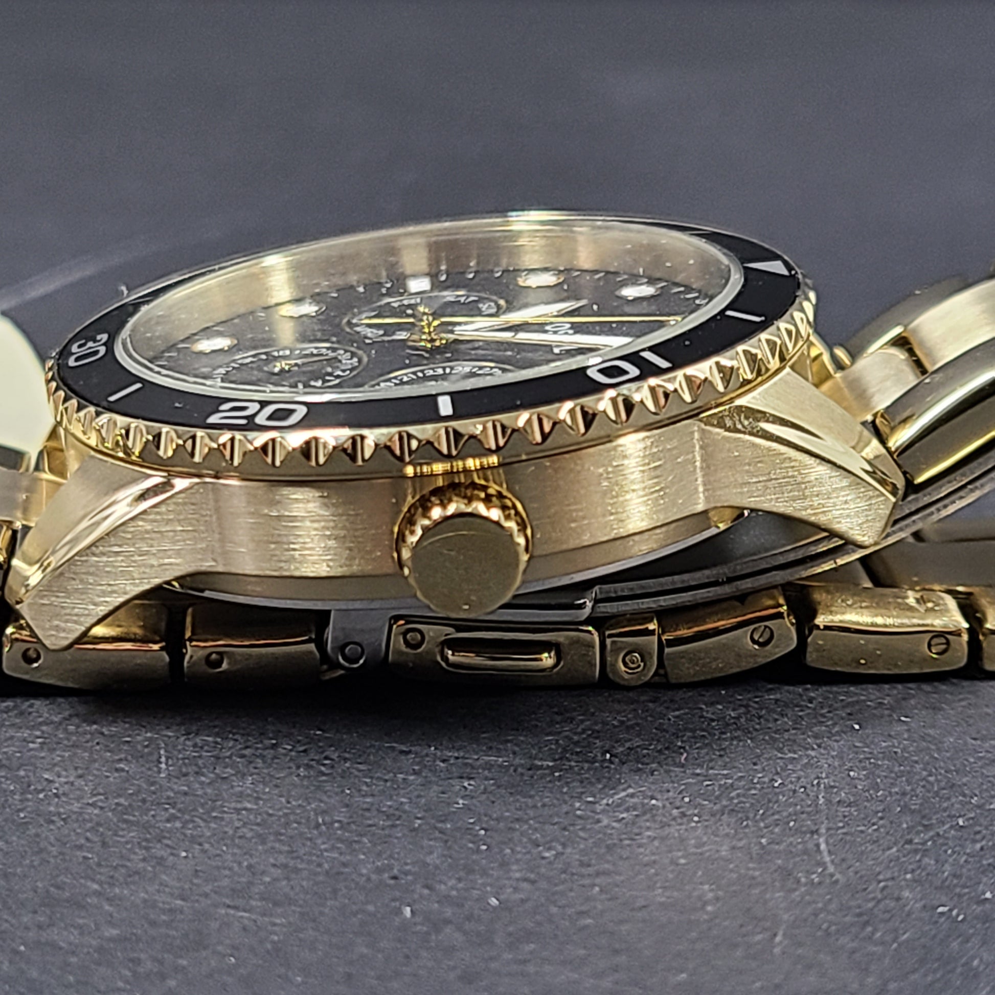 Gold-tone stainless steel his-and-her multifunction watch set with black sunray dials and interchangeable straps.