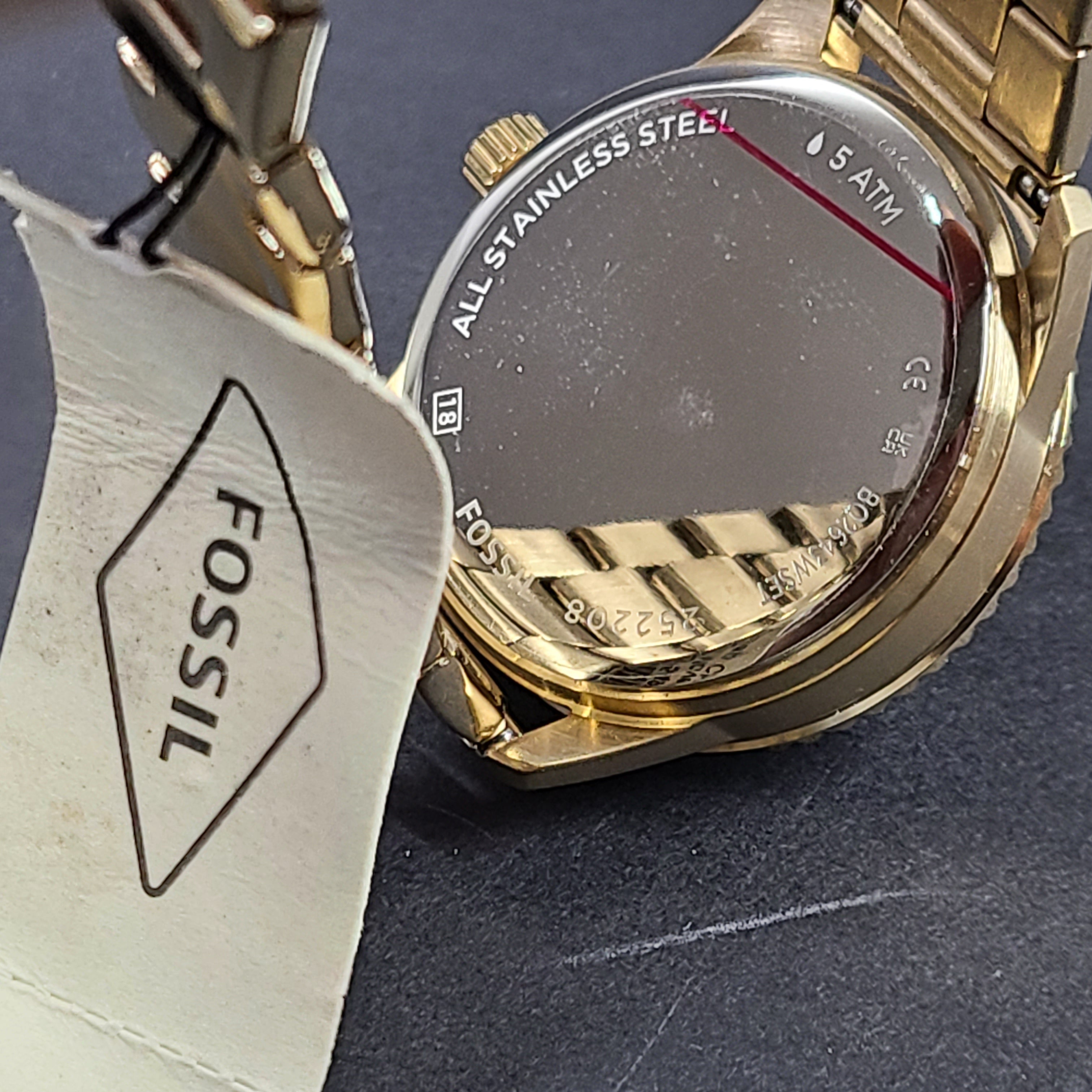 Gold-tone stainless steel his-and-her multifunction watch set with black sunray dials and interchangeable straps.