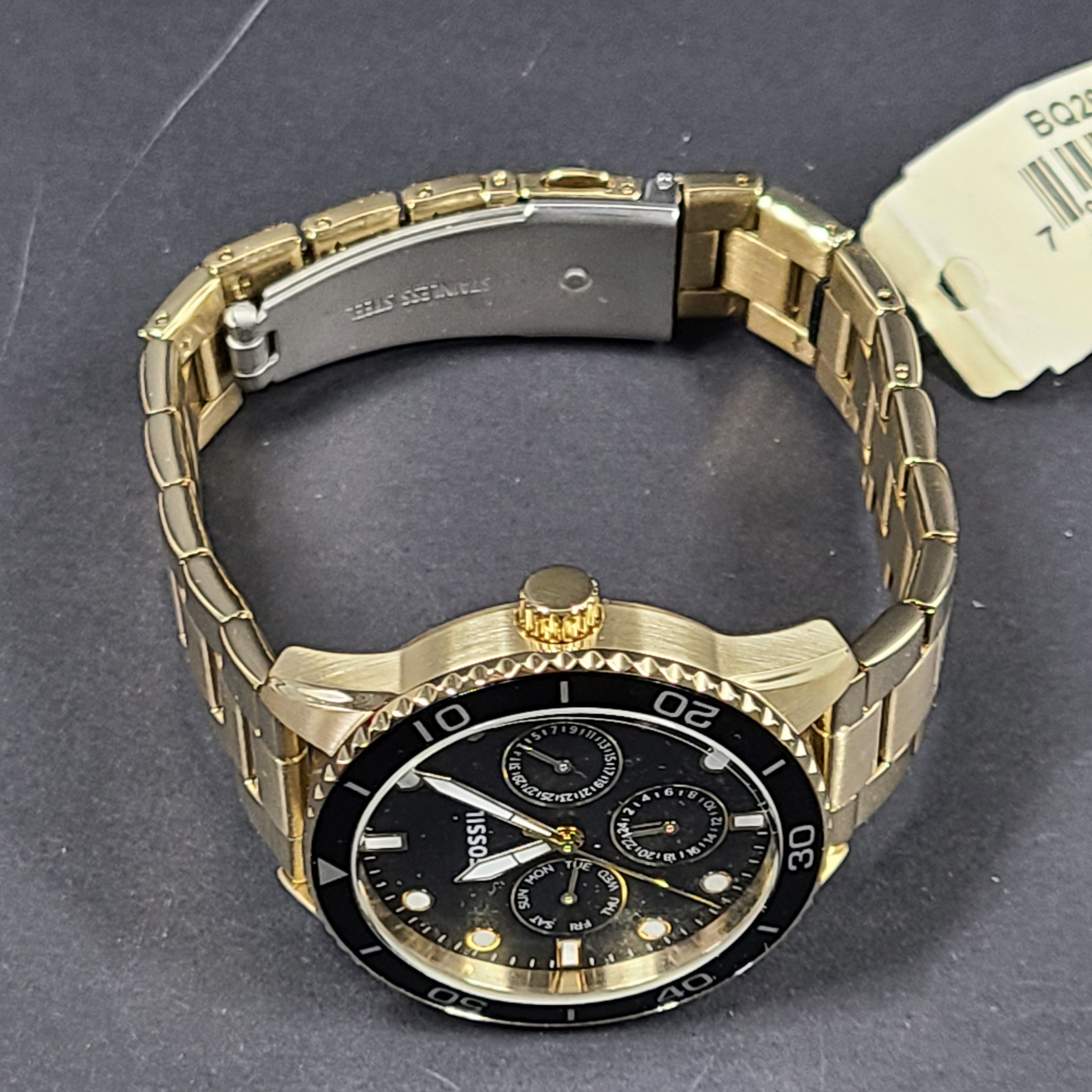 Gold-tone stainless steel his-and-her multifunction watch set with black sunray dials and interchangeable straps.