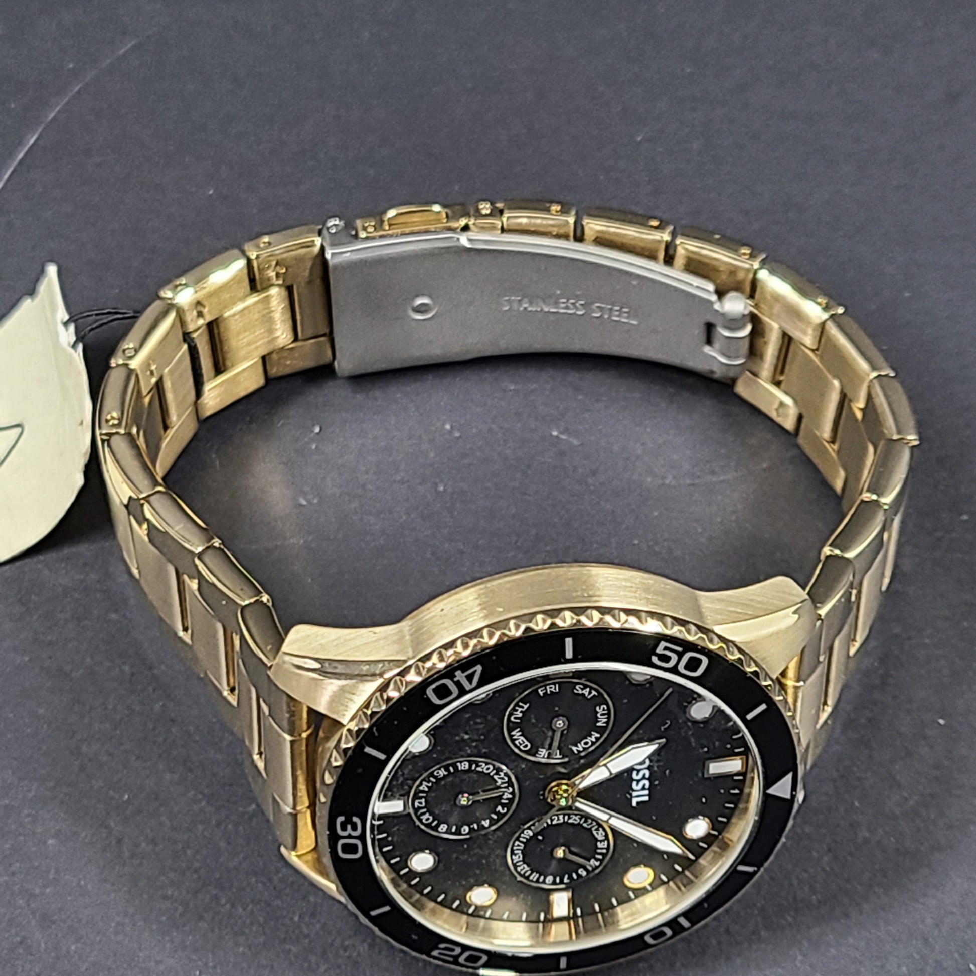 Gold-tone stainless steel his-and-her multifunction watch set with black sunray dials and interchangeable straps.