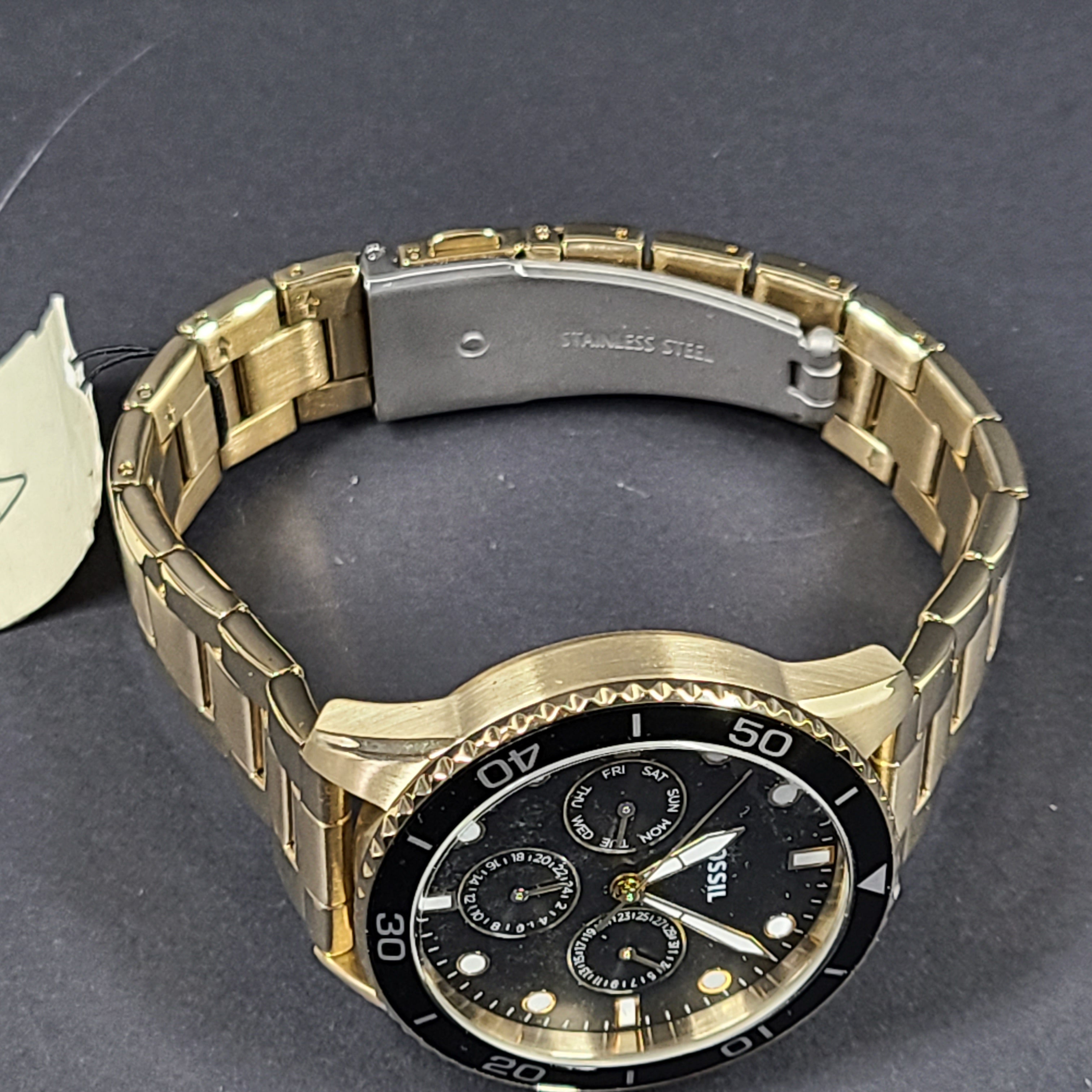 Gold-tone stainless steel his-and-her multifunction watch set with black sunray dials and interchangeable straps.
