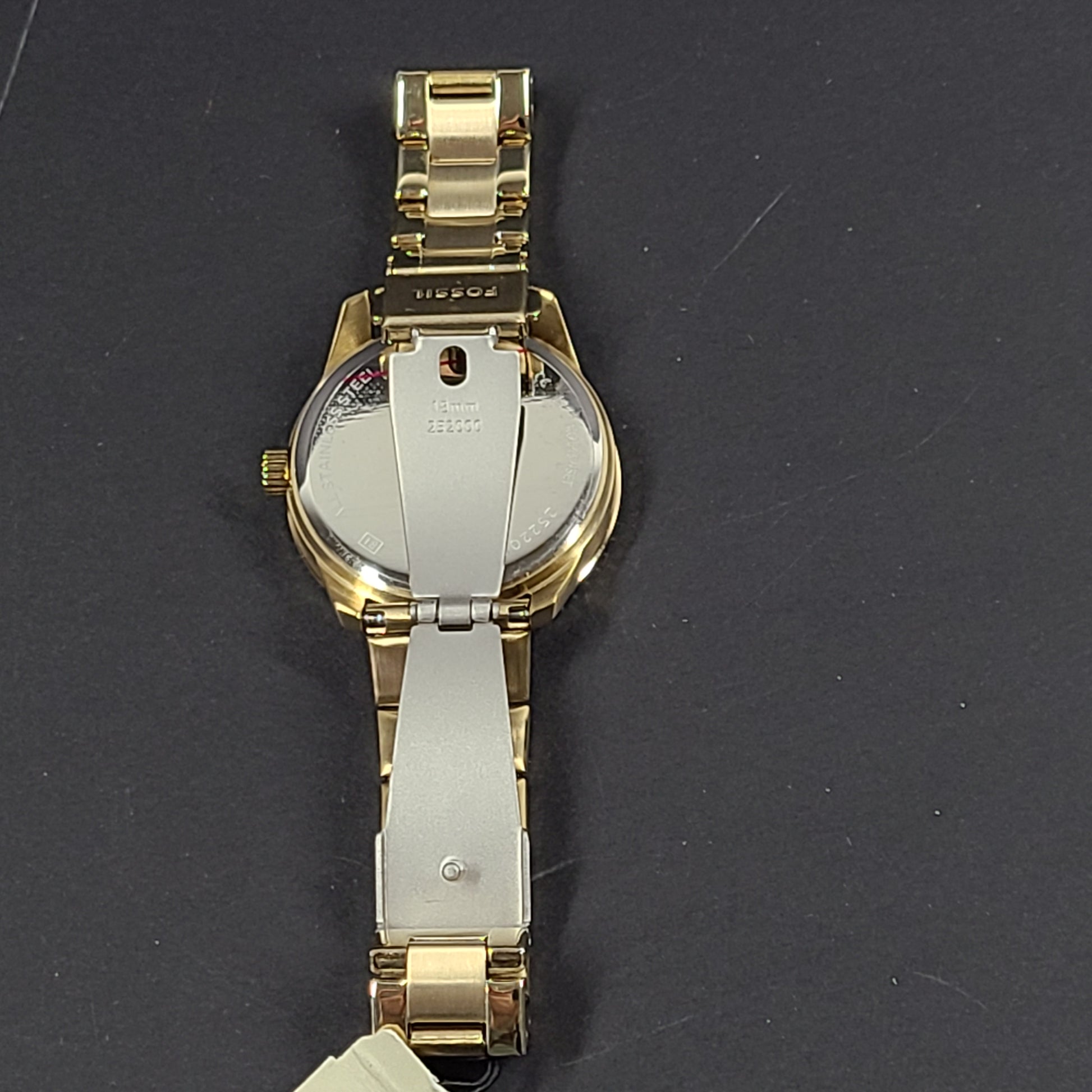 Gold-tone stainless steel his-and-her multifunction watch set with black sunray dials and interchangeable straps.