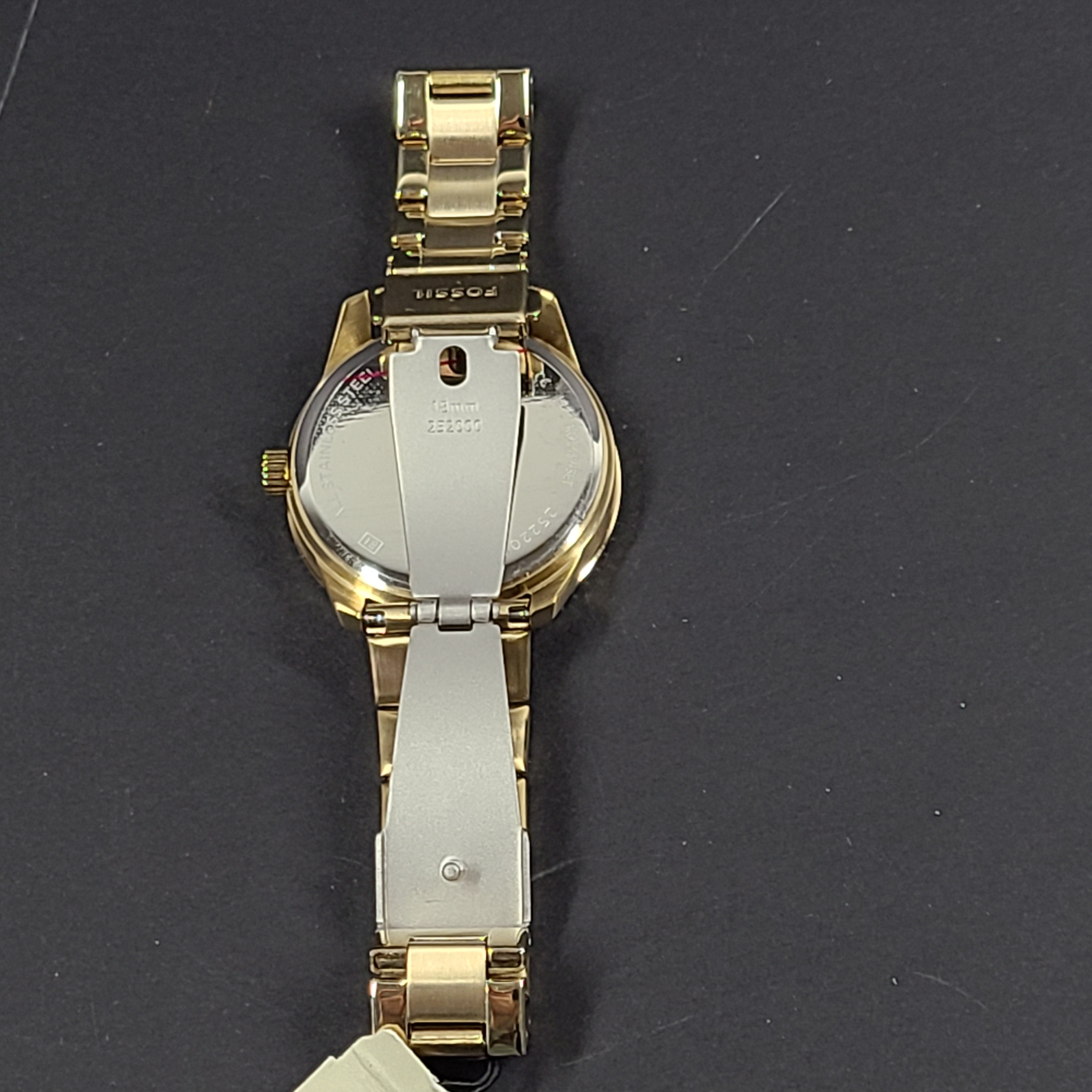 Gold-tone stainless steel his-and-her multifunction watch set with black sunray dials and interchangeable straps.