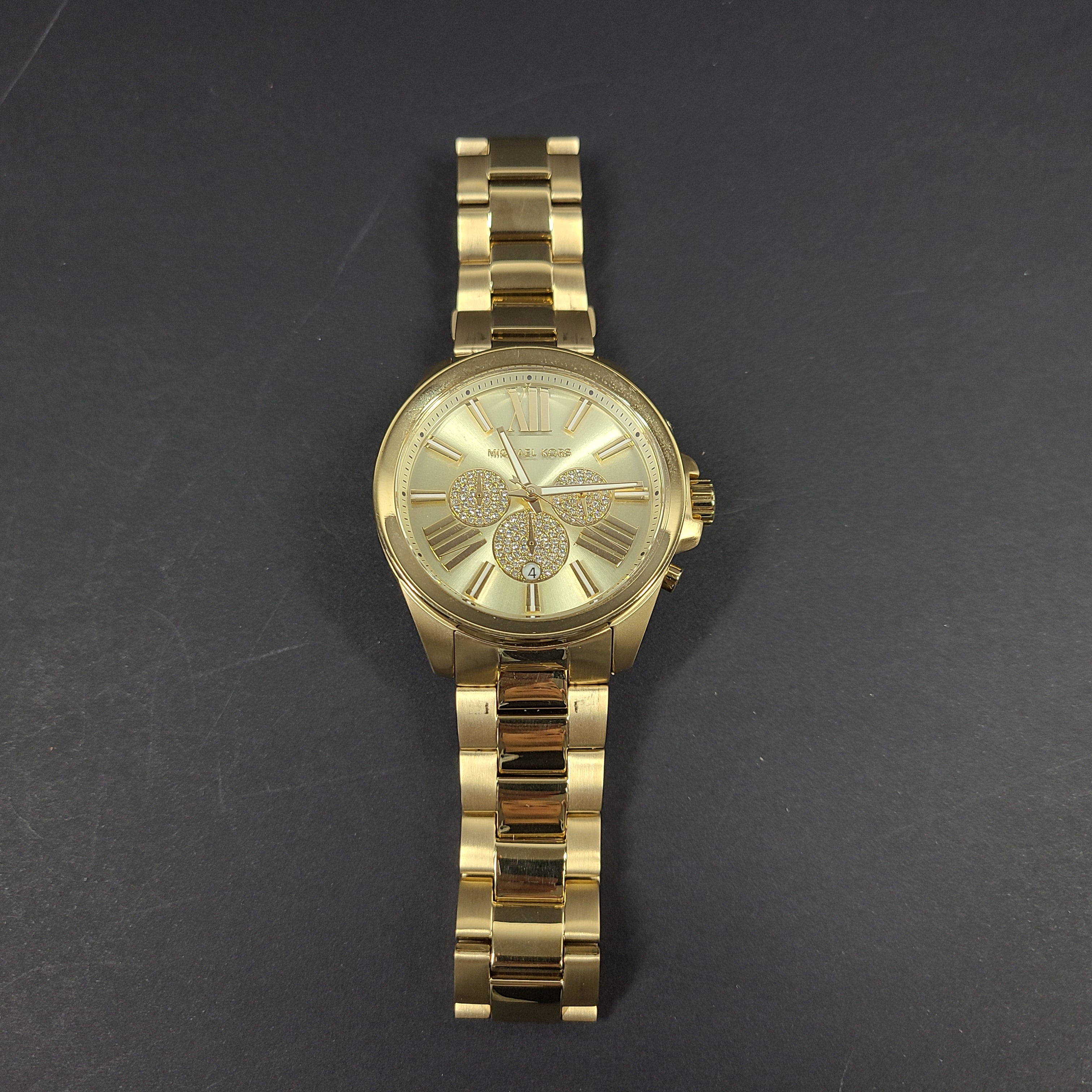Gold-tone Michael Kors Wren chronograph watch with stainless steel bracelet and pavé sub-dials.