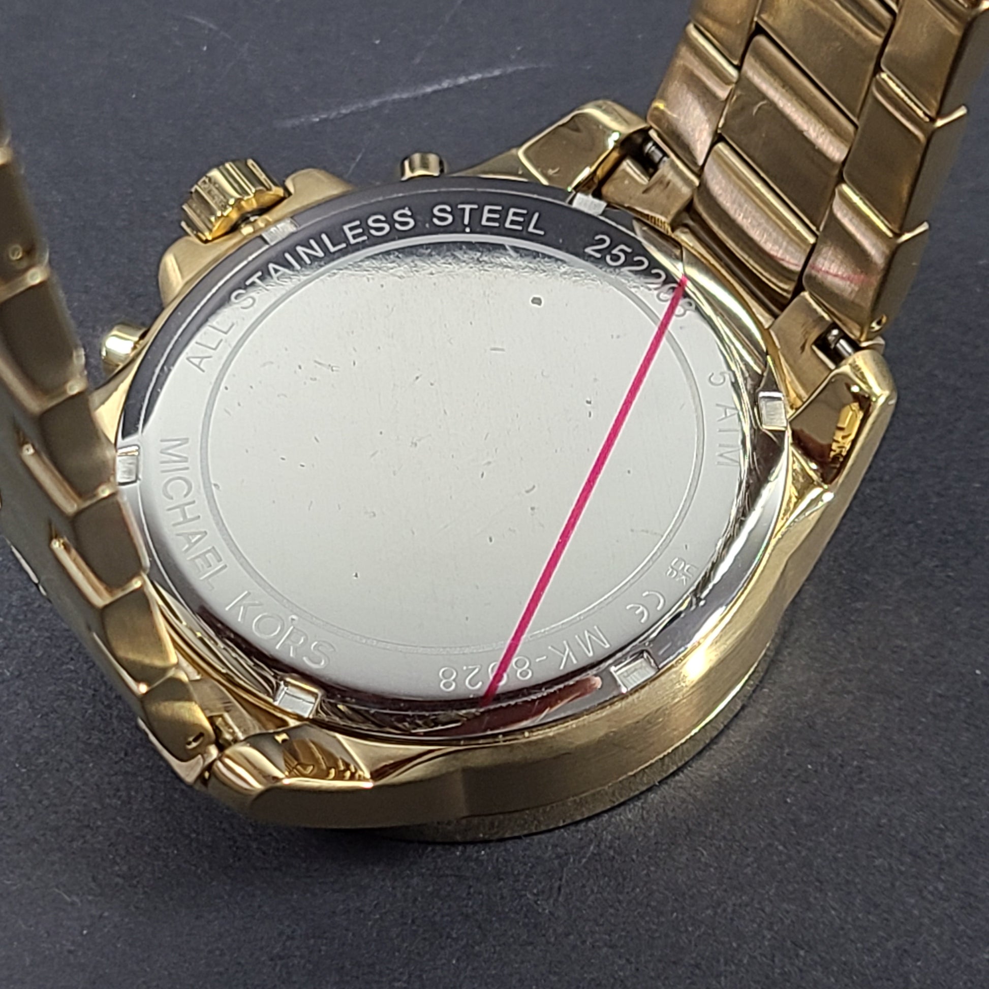 Gold-tone Michael Kors Wren chronograph watch with stainless steel bracelet and pavé sub-dials.