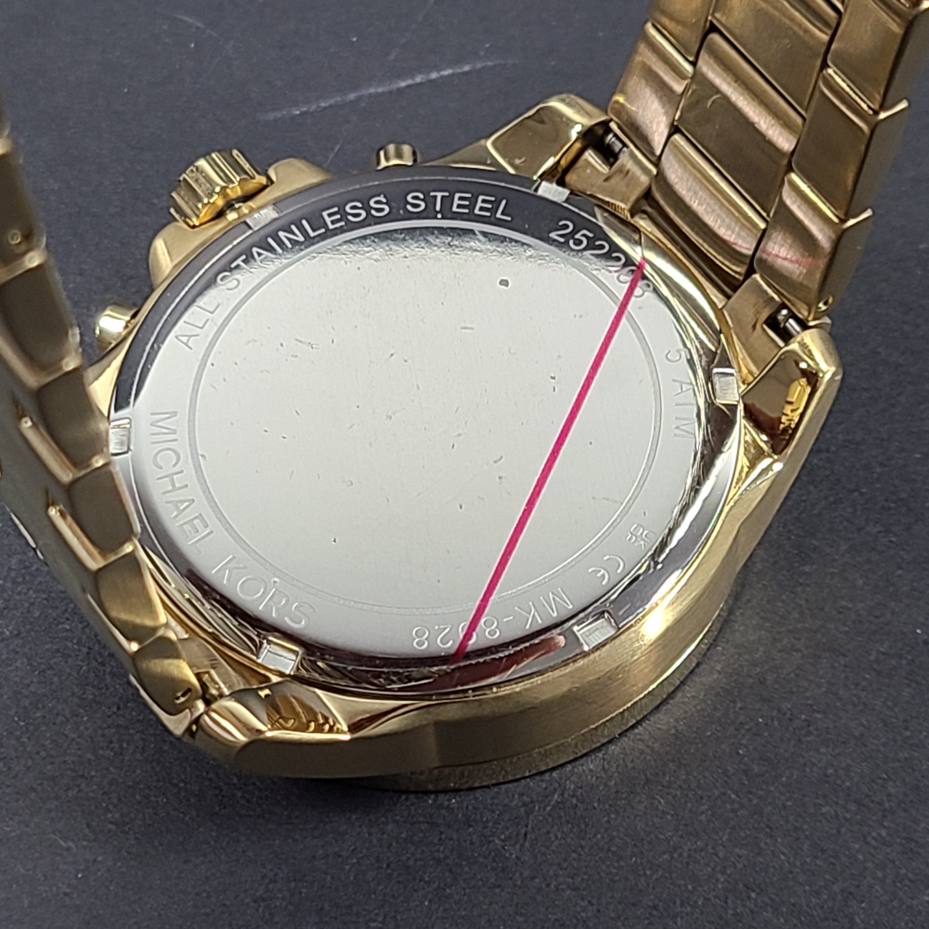 Gold-tone Michael Kors Wren chronograph watch with stainless steel bracelet and pavé sub-dials.