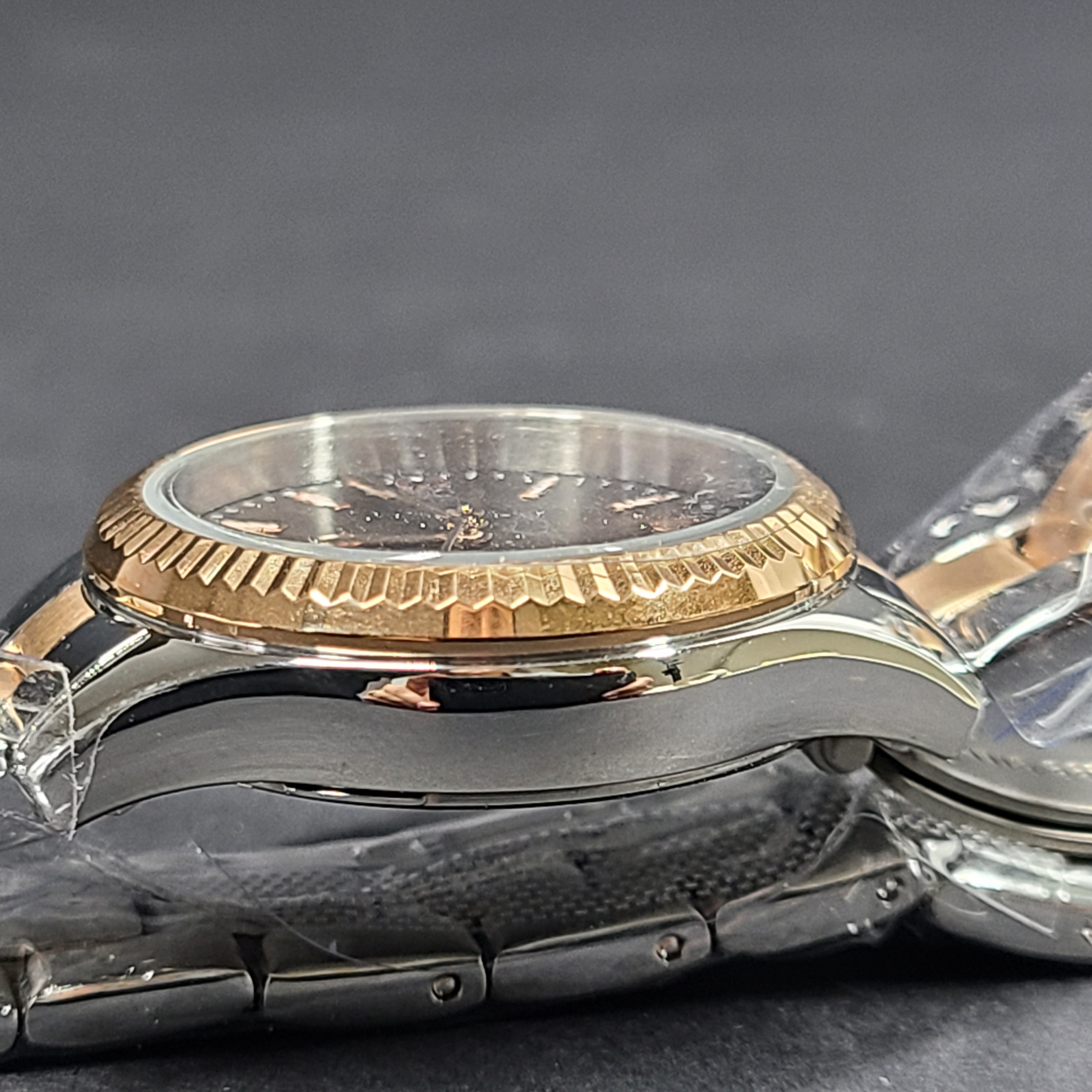 A two-tone Fossil Rye wristwatch with silver and gold stainless-steel bracelet and a date window.