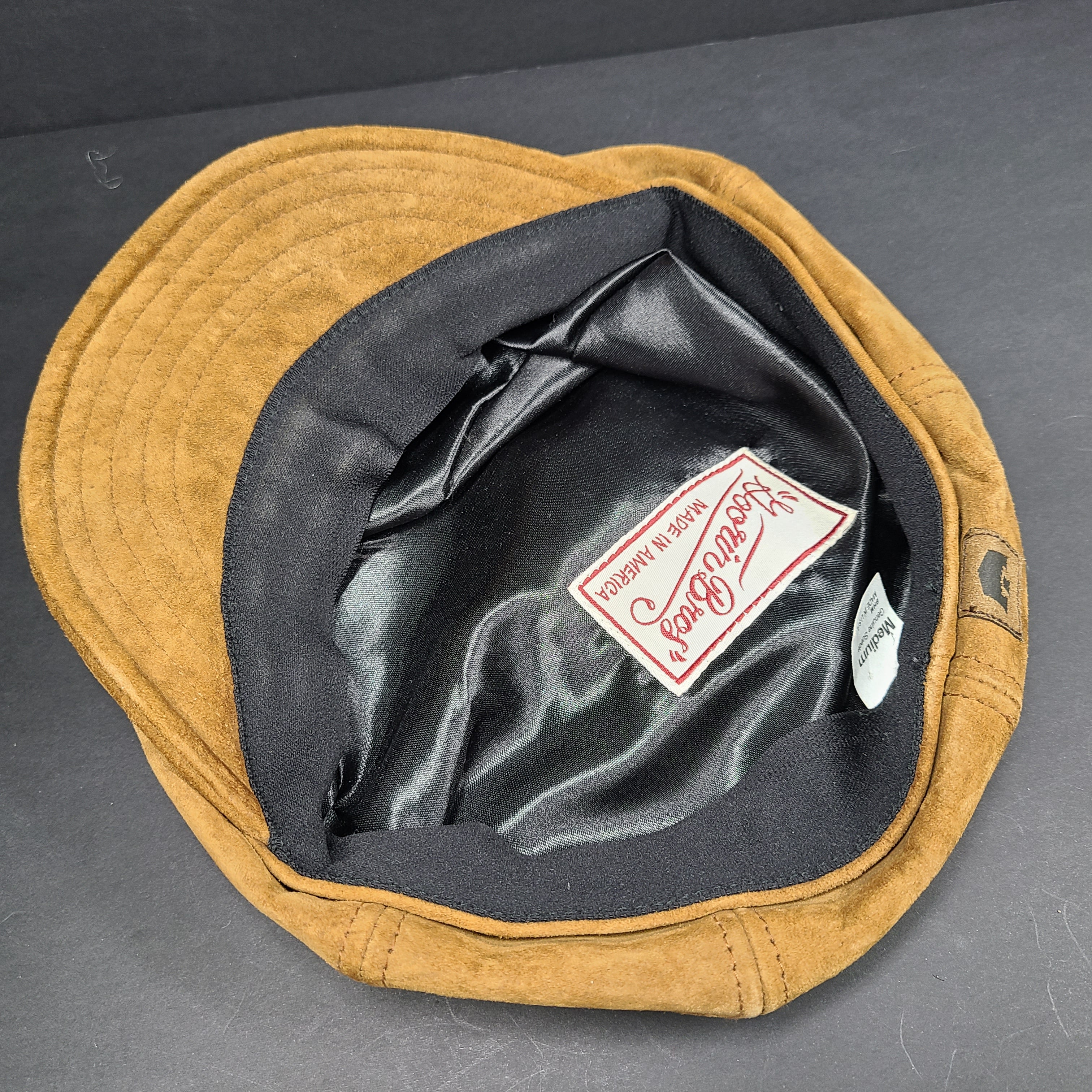Goorin Bros medium brown suede cap with rounded crown and short brim.