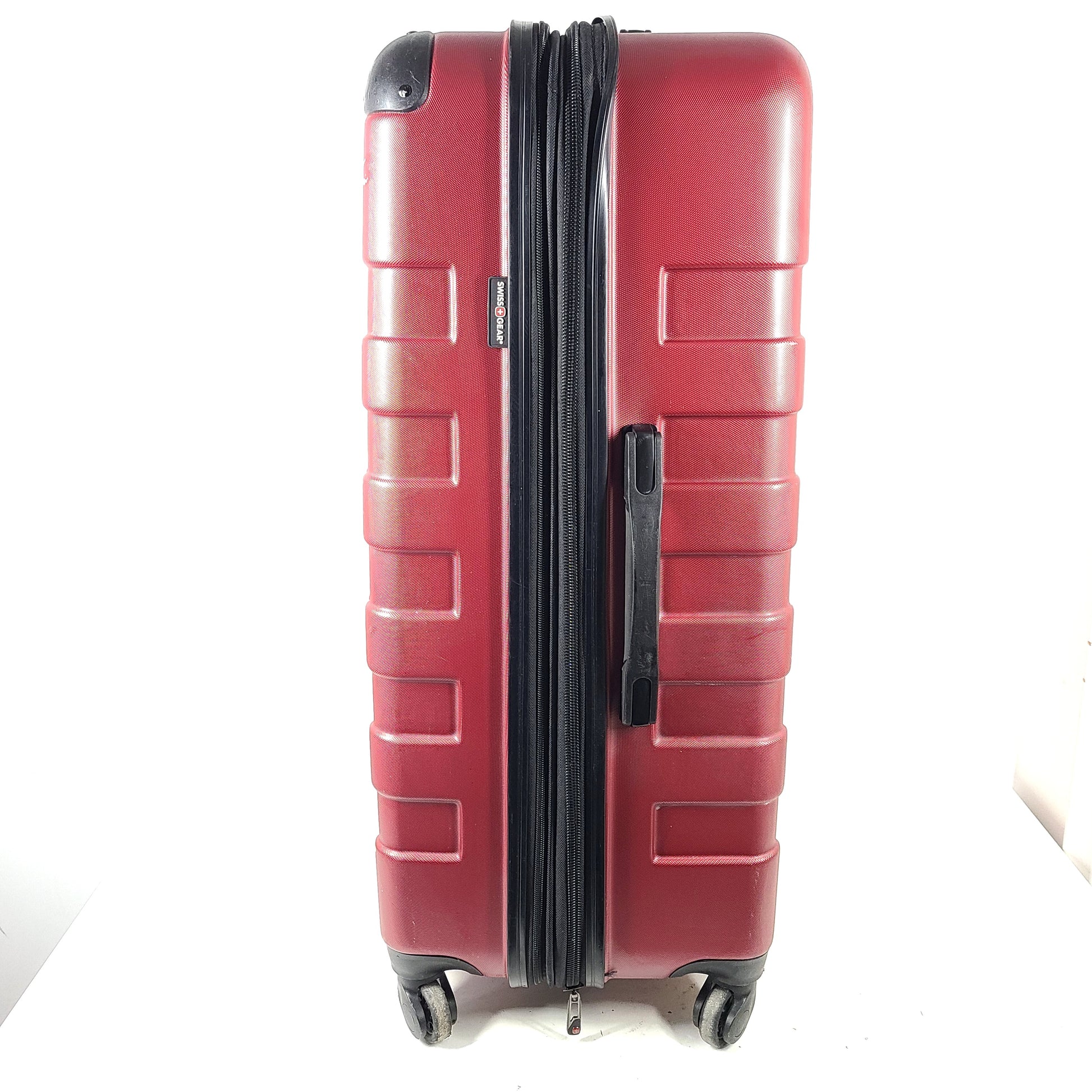 Red SwissGear SW25083 spinner suitcase with four multi-directional wheels and a telescoping handle.