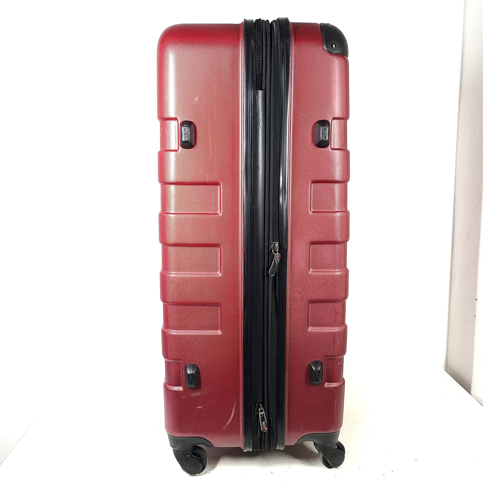 Red SwissGear SW25083 spinner suitcase with four multi-directional wheels and a telescoping handle.