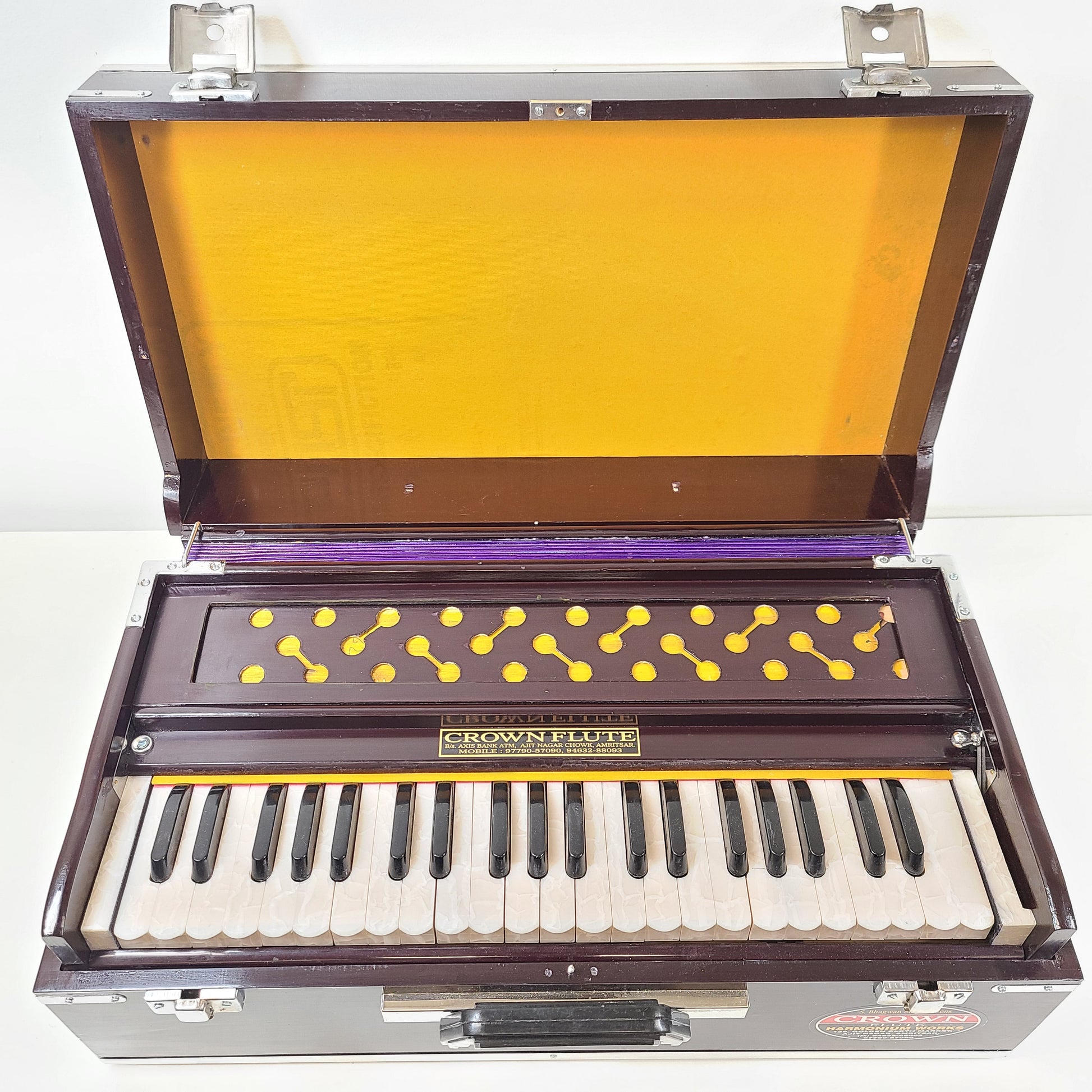 Classic S. Bhagwan Singh & Sons Crown Flute harmonium in black, blue, and brown with a carrying case included.