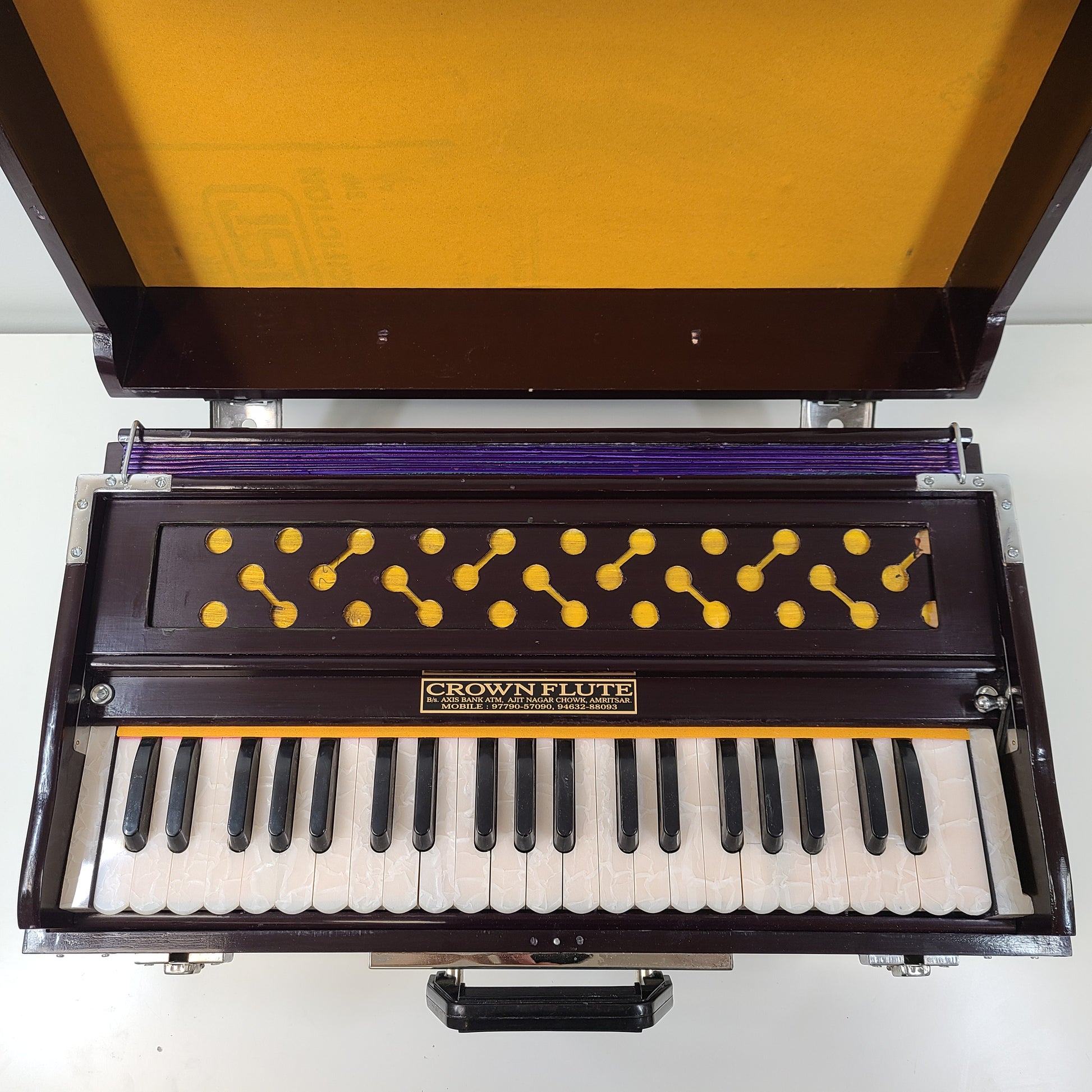 Classic S. Bhagwan Singh & Sons Crown Flute harmonium in black, blue, and brown with a carrying case included.