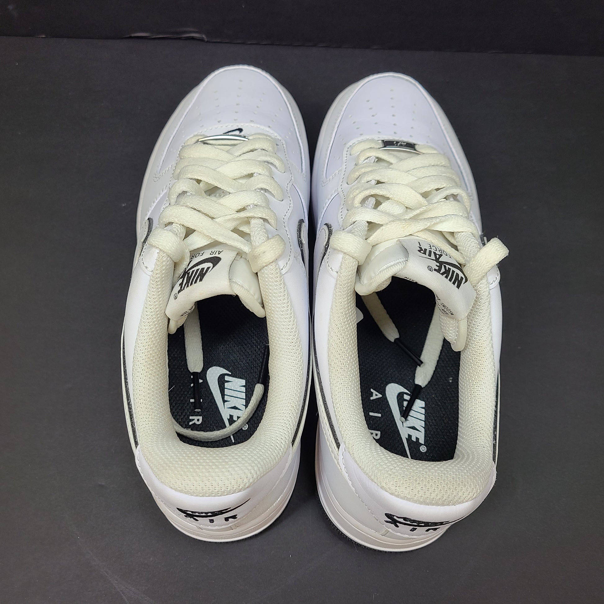 Classic Nike Air Force 1 Low in white with black accents, size US 7.5, model DV0818-103.