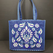 America & Beyond embroidered blue and white tote with floral and leopard interior and interior label reading AMERICA & BEYOND.
