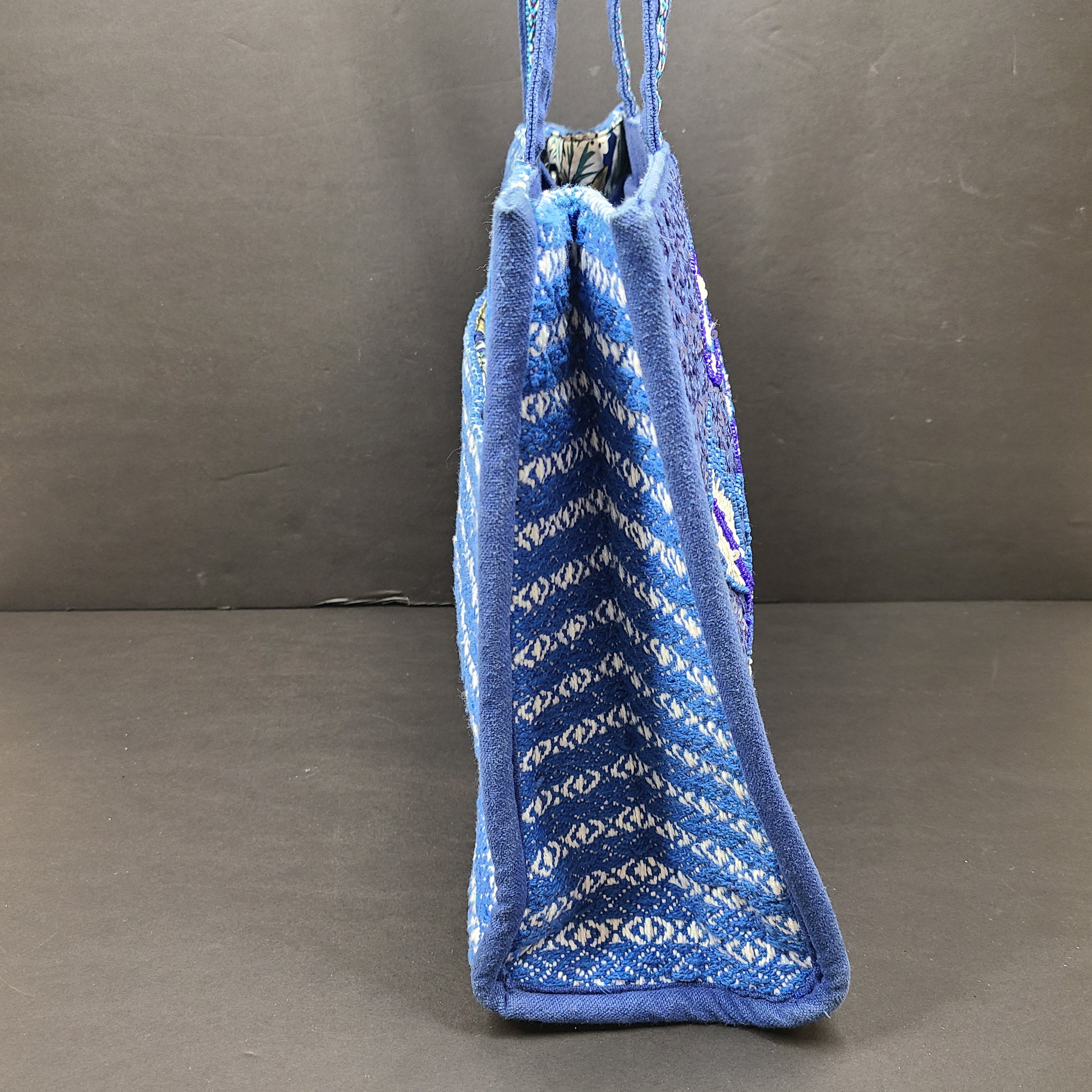 America & Beyond embroidered blue and white tote with floral and leopard interior and interior label reading AMERICA & BEYOND.