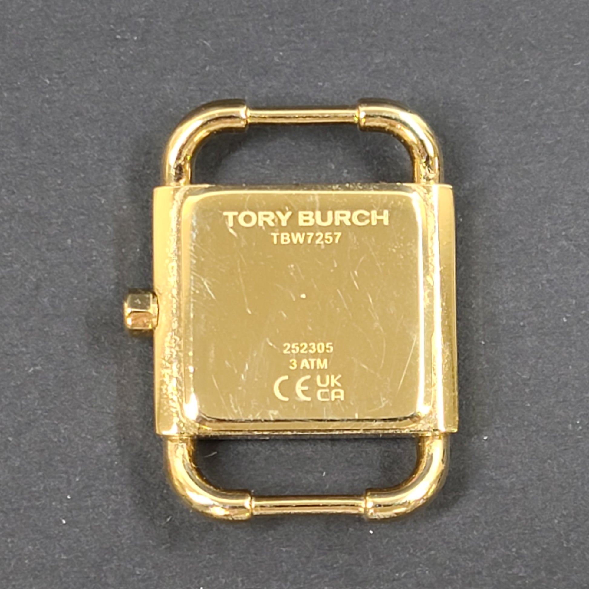 Tory Burch two-tone stainless steel bracelet watch TBW7257 with round dial and logo engraving.