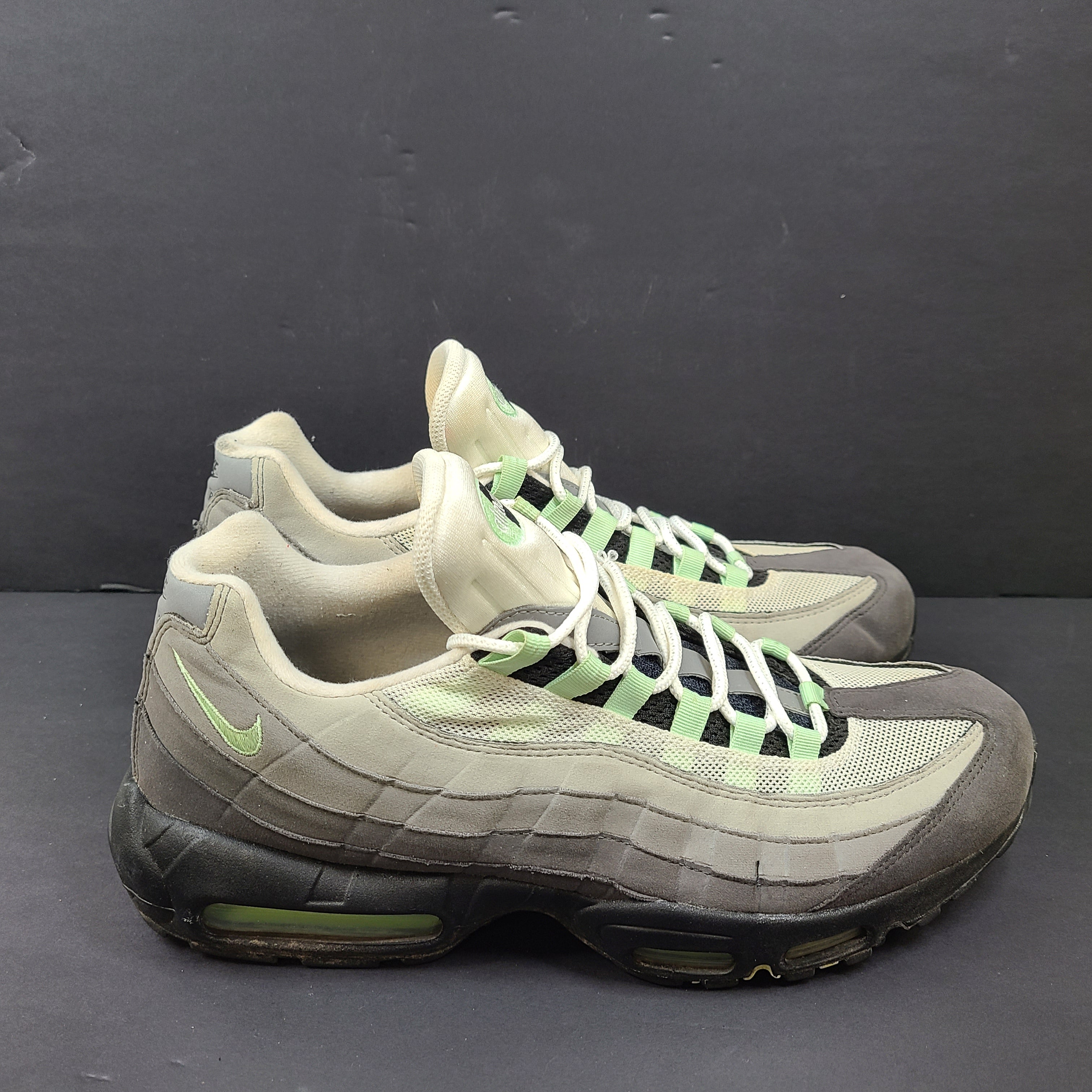 Nike Air Max 95 in gray and mint green, US size 13, with wear on soles and fabric.