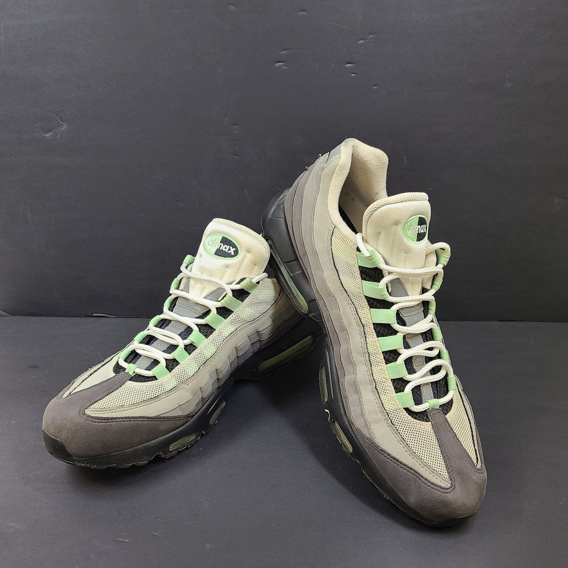 Nike Air Max 95 in gray and mint green, US size 13, with wear on soles and fabric.