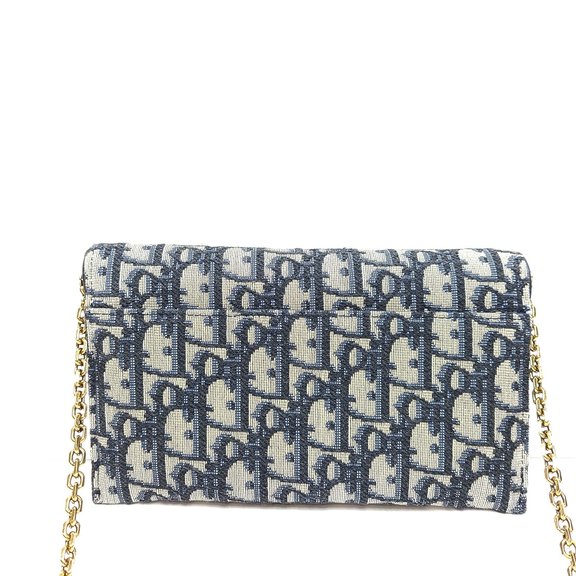 Christian Dior blue leather handbag with a gold chain strap and matching pouch.