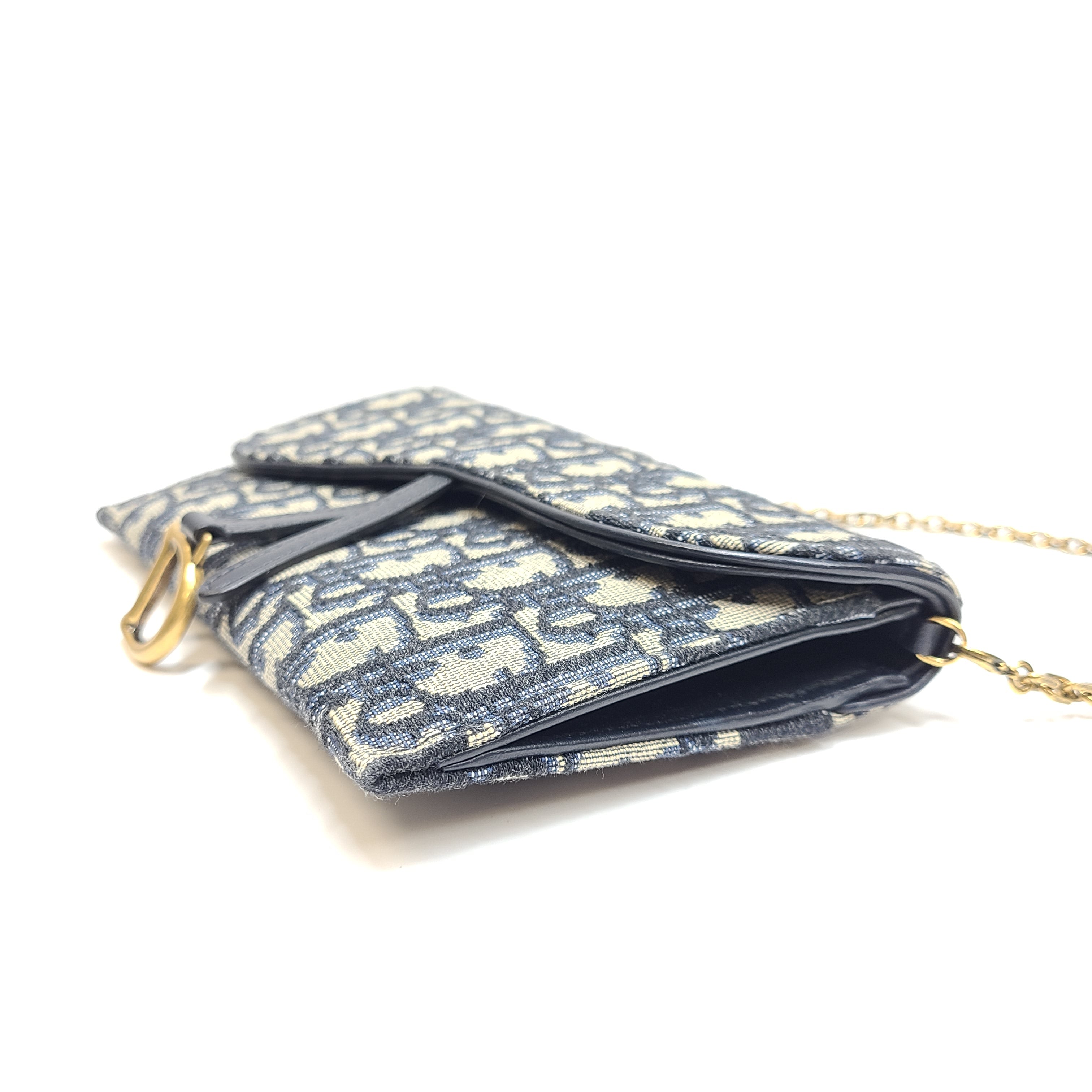 Christian Dior blue leather handbag with a gold chain strap and matching pouch.