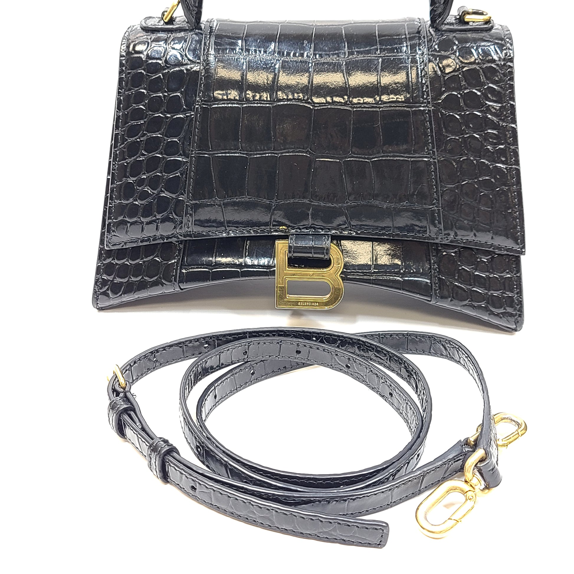 Balenciaga crocodile-embossed black leather handbag with branded buckle and detachable strap.