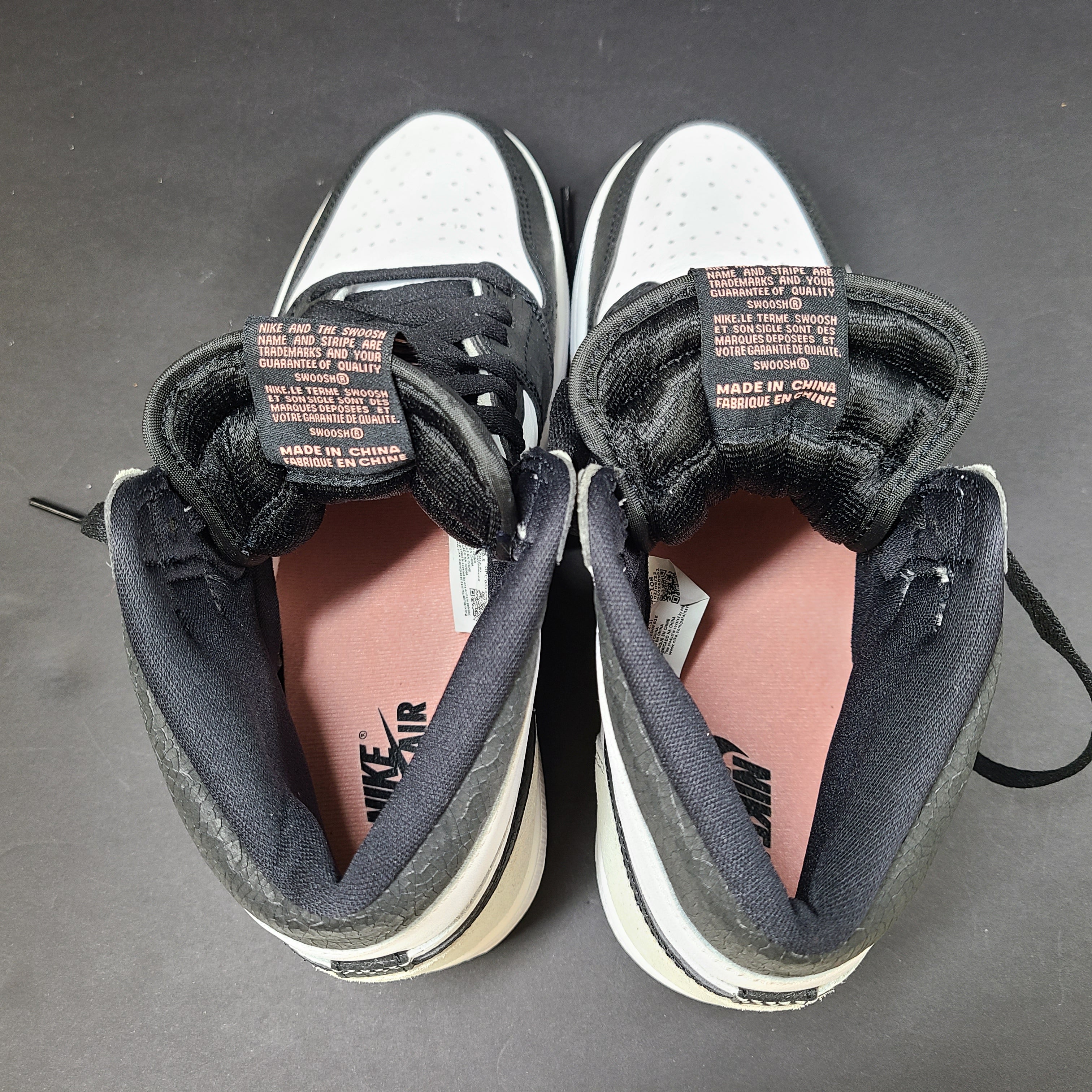 Nike Air Jordan 1 High in black, white and grey with Bleached Coral highlights.