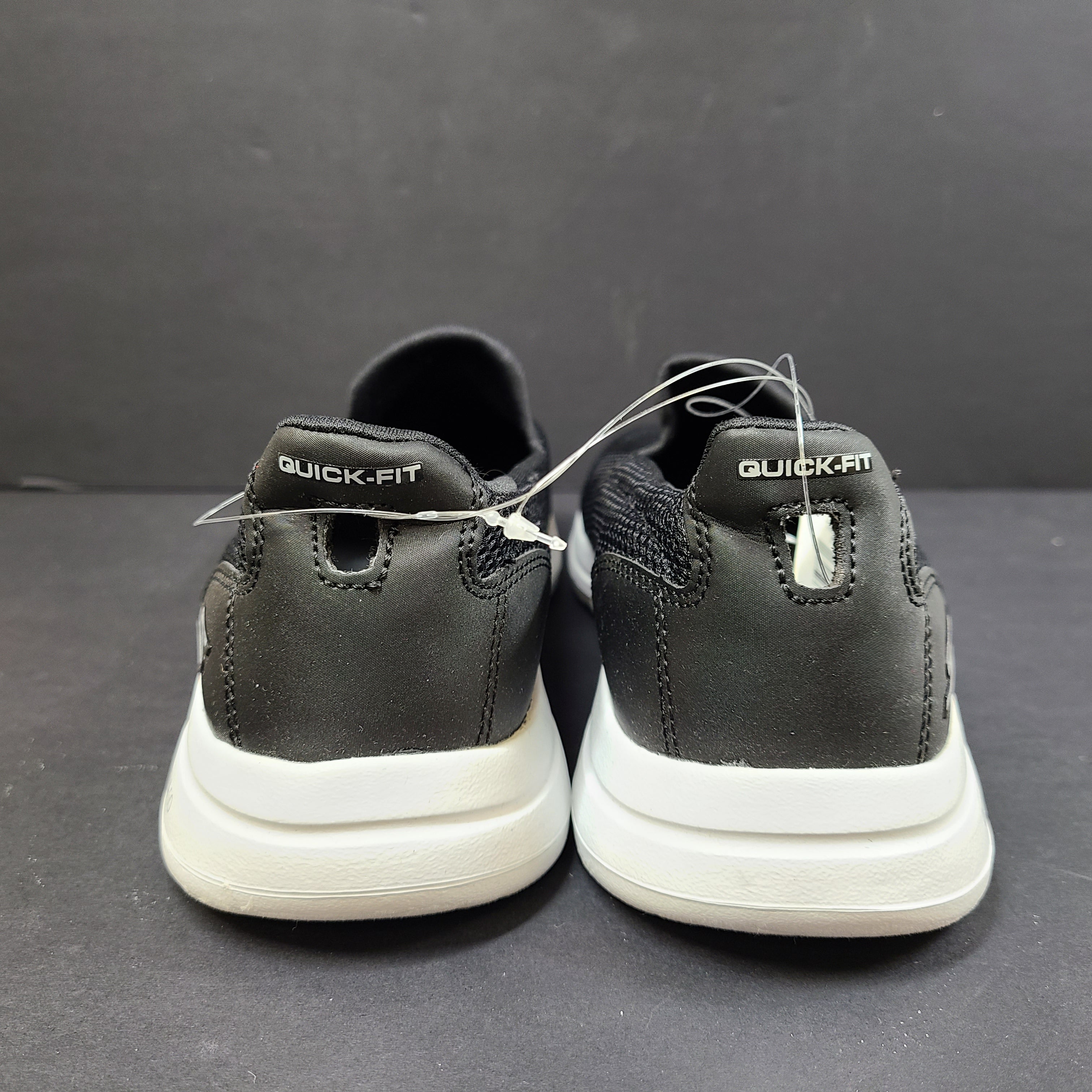 Black and white Skechers Go Walk 5 slip-on shoes with responsive cushioning and Quick-Fit heel for easy on and off.