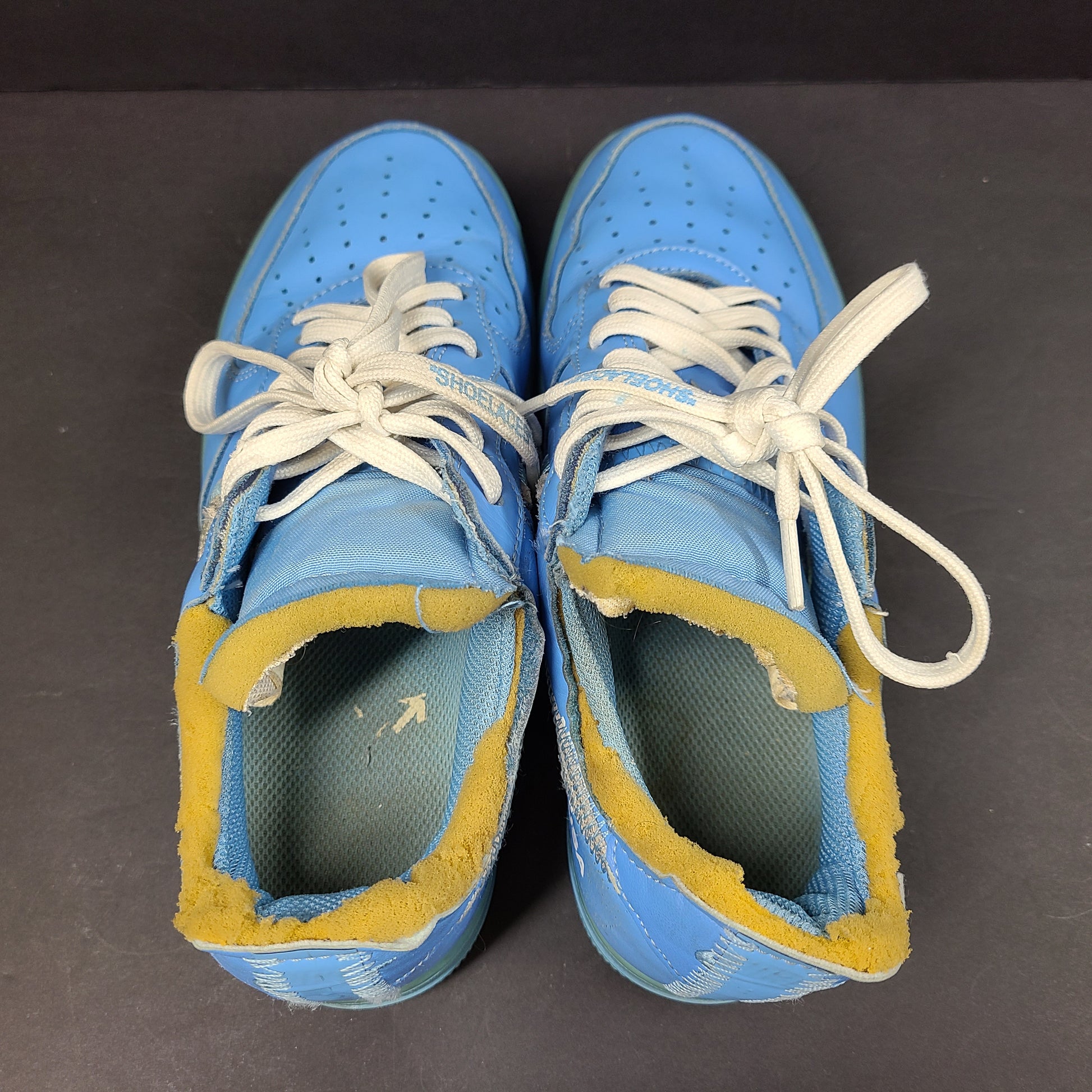 Nike Air Force 1 low-top sneakers in blue and yellow, size US 7, featuring "SHOELACES" text on the laces and "AIR" on the sole.