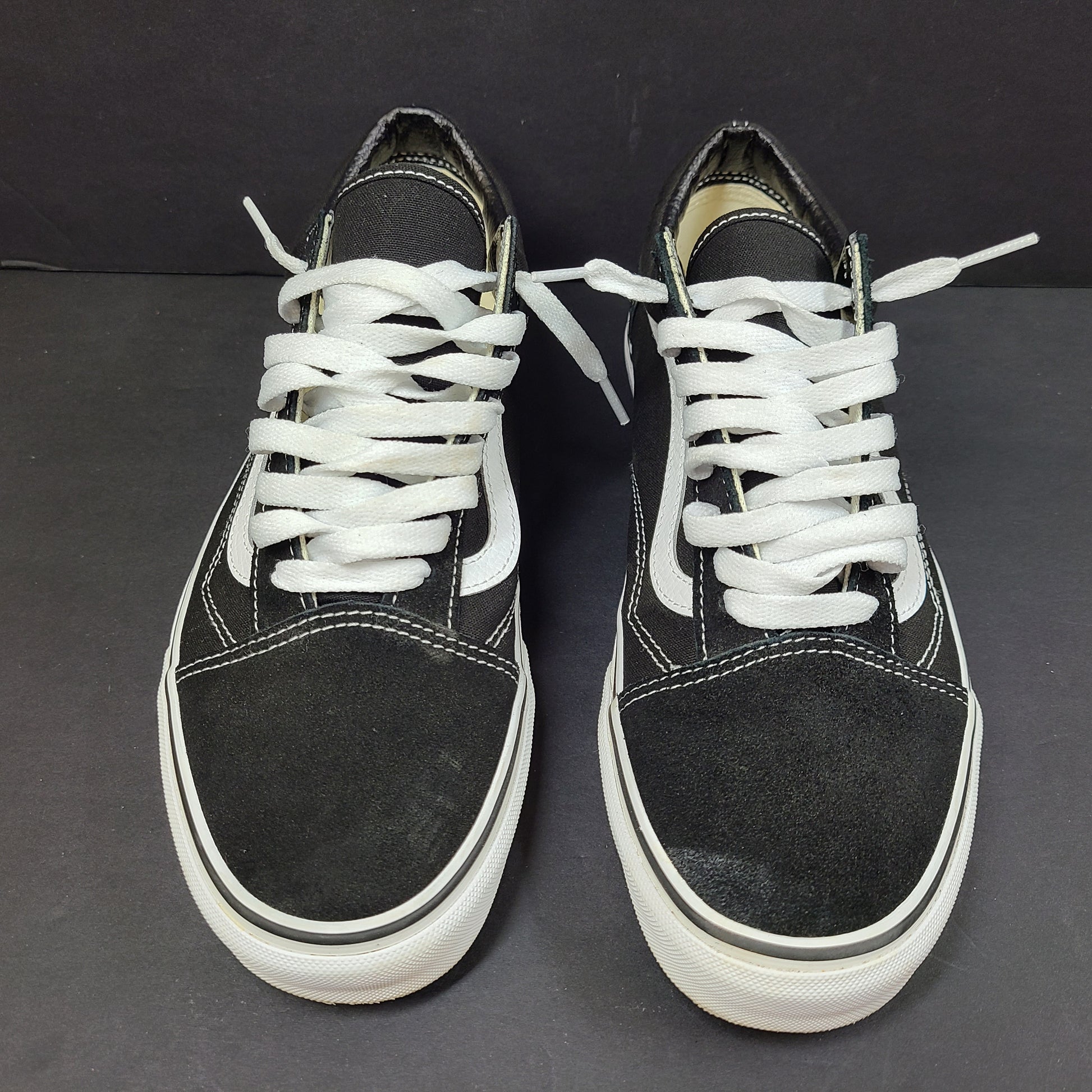 Low-top Vans Old Skool skate shoe in black with a white side stripe and vulcanized sole.