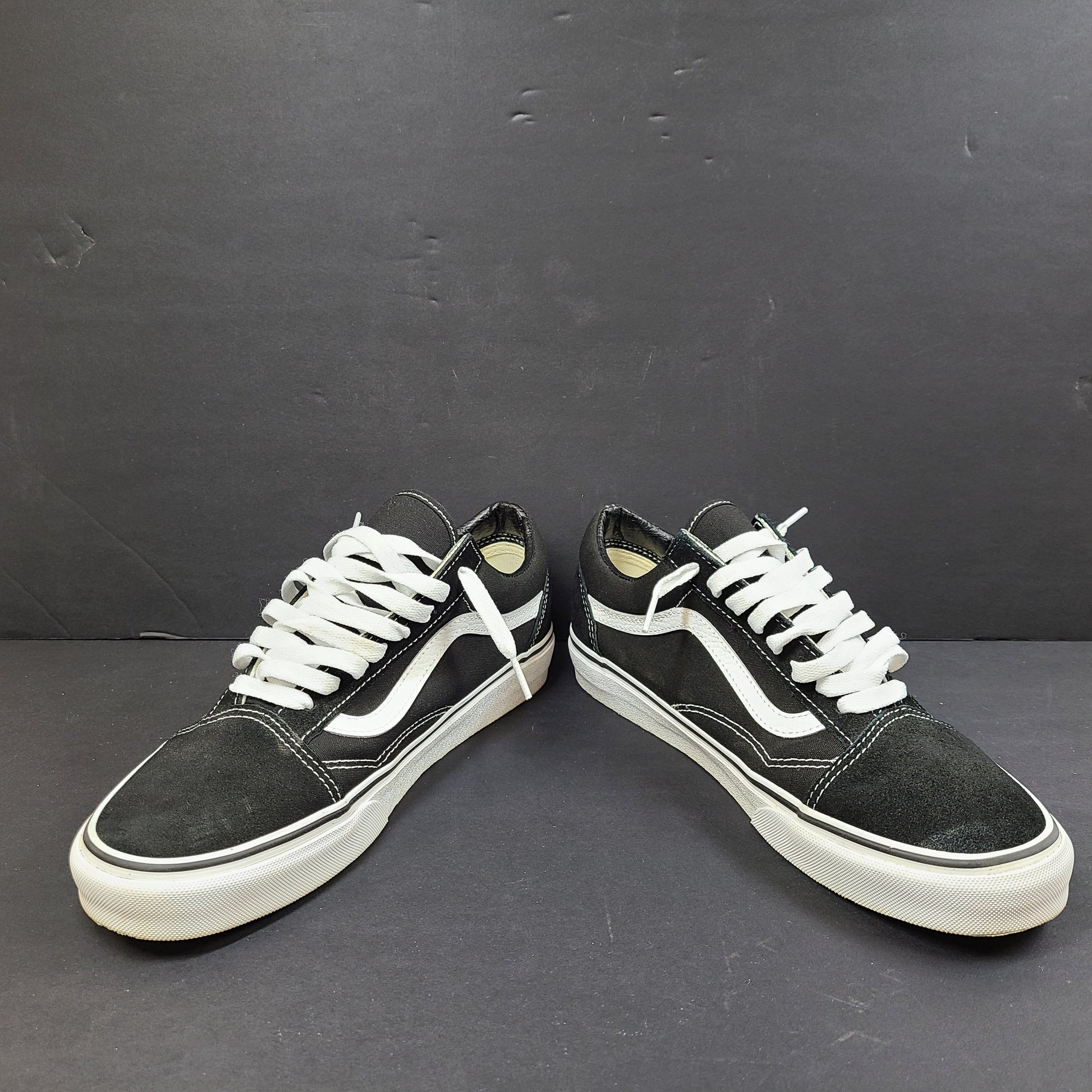 Low-top Vans Old Skool skate shoe in black with a white side stripe and vulcanized sole.